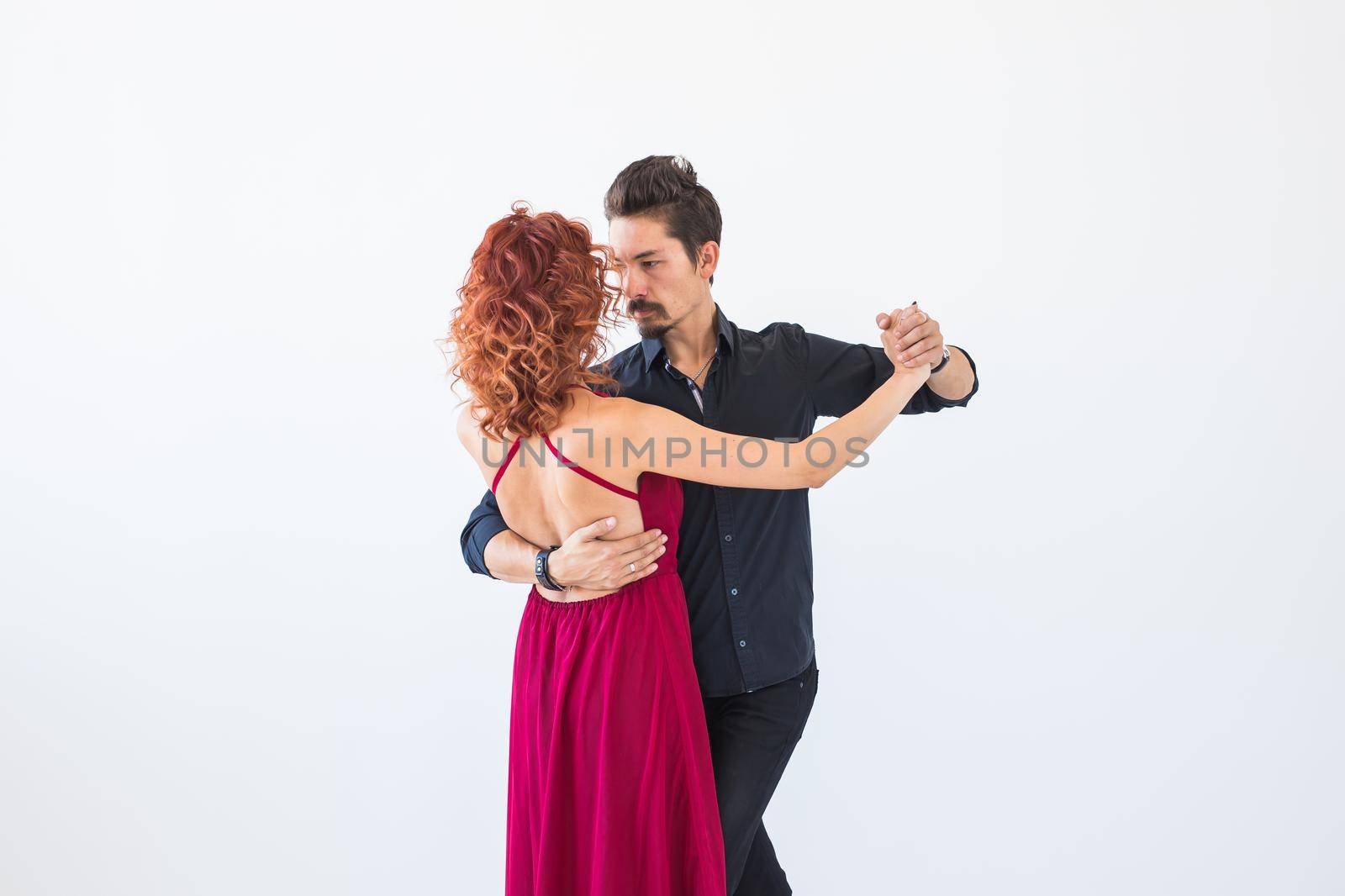 Romantic, social dance, people concept - couple dancing the salsa or kizomba or tango on white background.