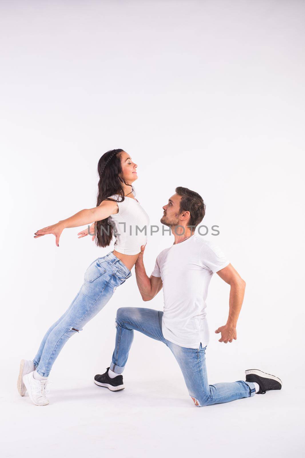 Young couple dancing social latin dance bachata, merengue, salsa. Two elegance pose on white background.