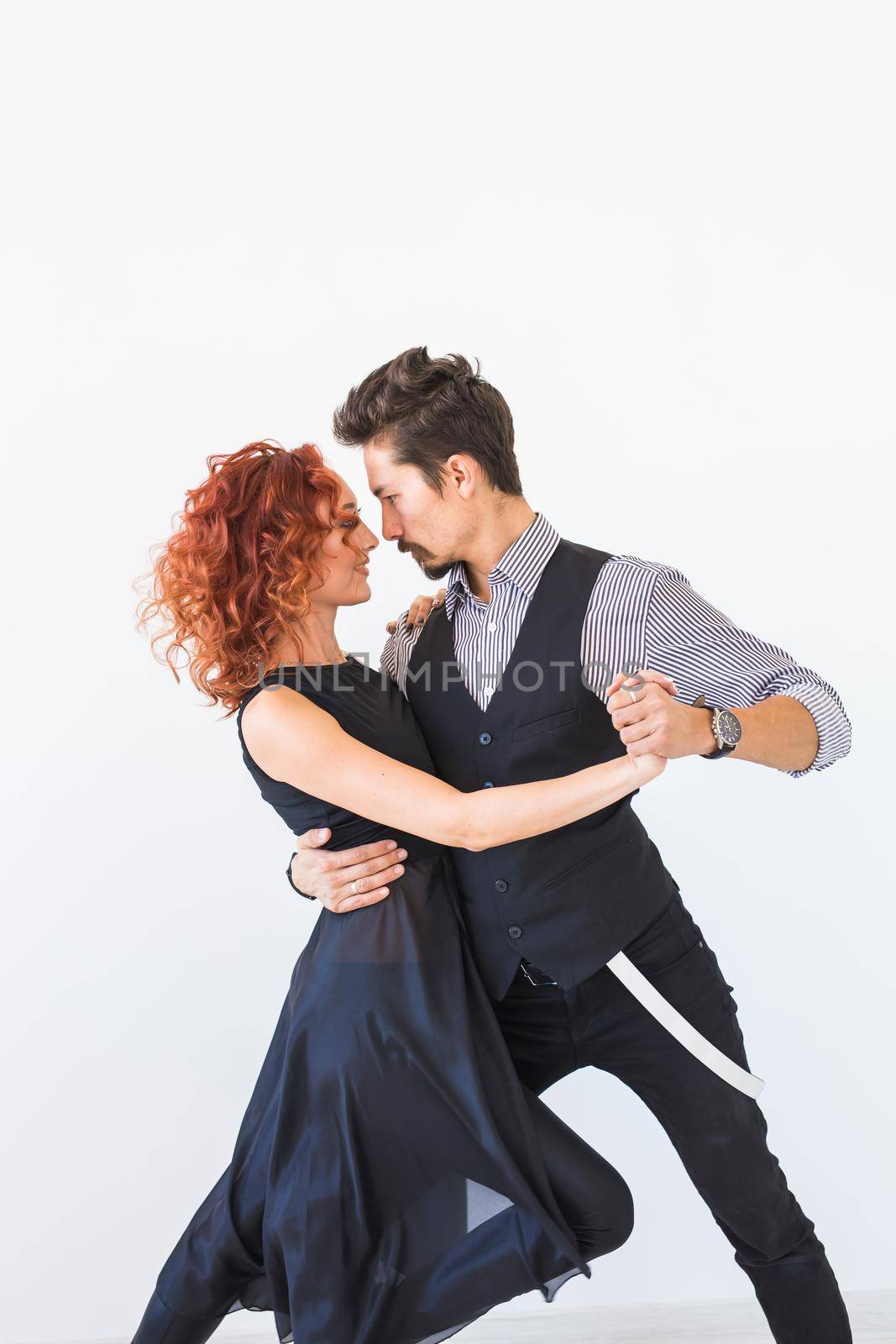 Social dance, bachata, kizomba, tango, salsa, people concept - Young couple dancing over white background by Satura86