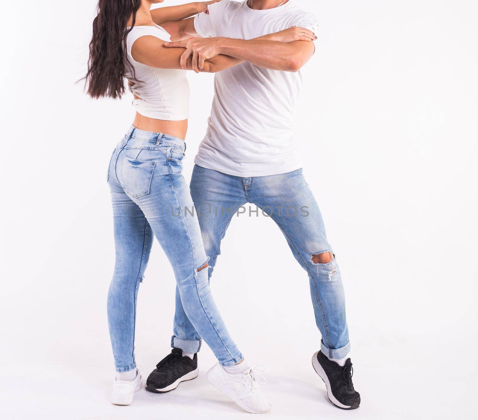 Salsa, kizomba and bachata dancers close up on white background. Social dance concept by Satura86