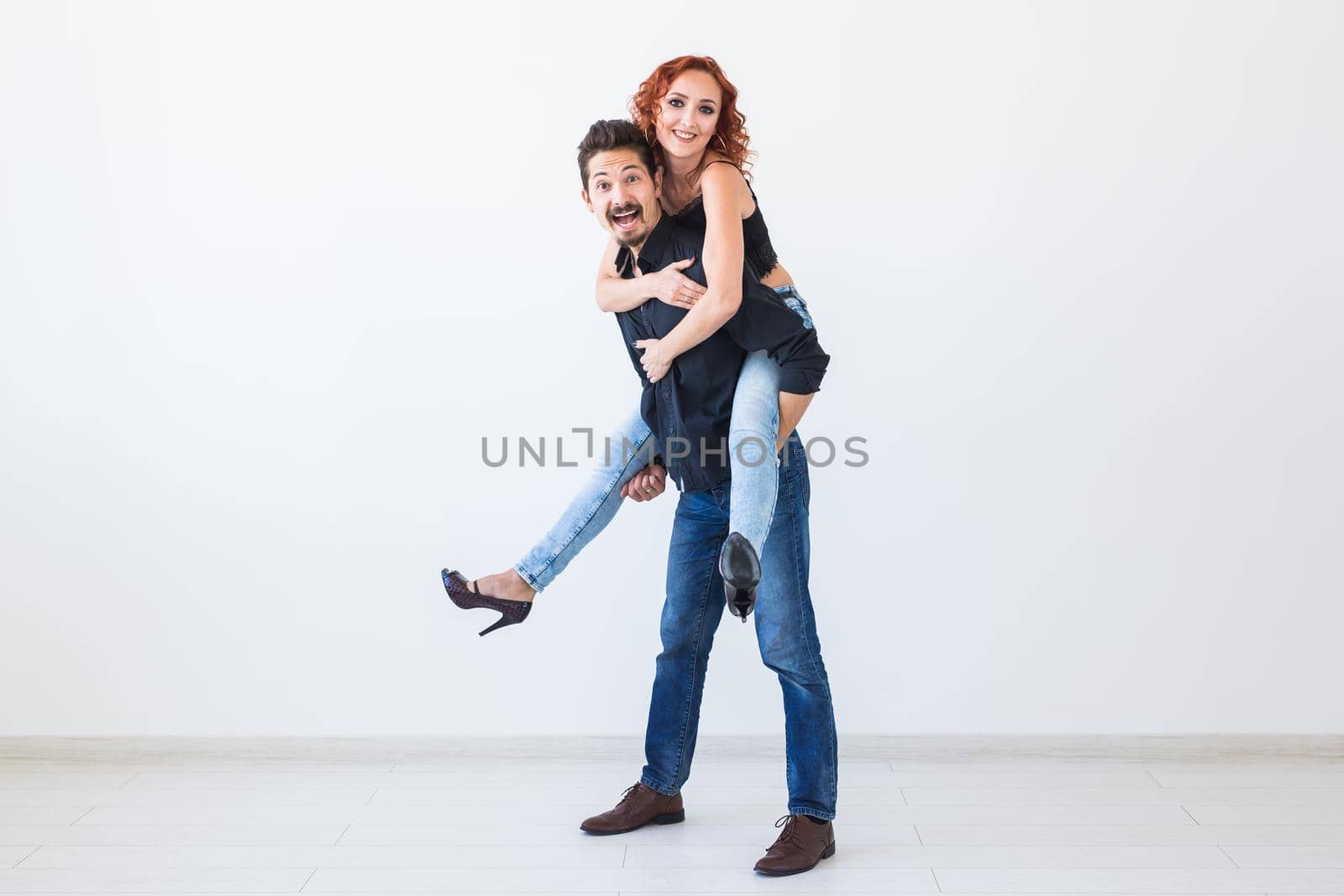 Friendship, people concept - young woman jumped on the man's back by Satura86