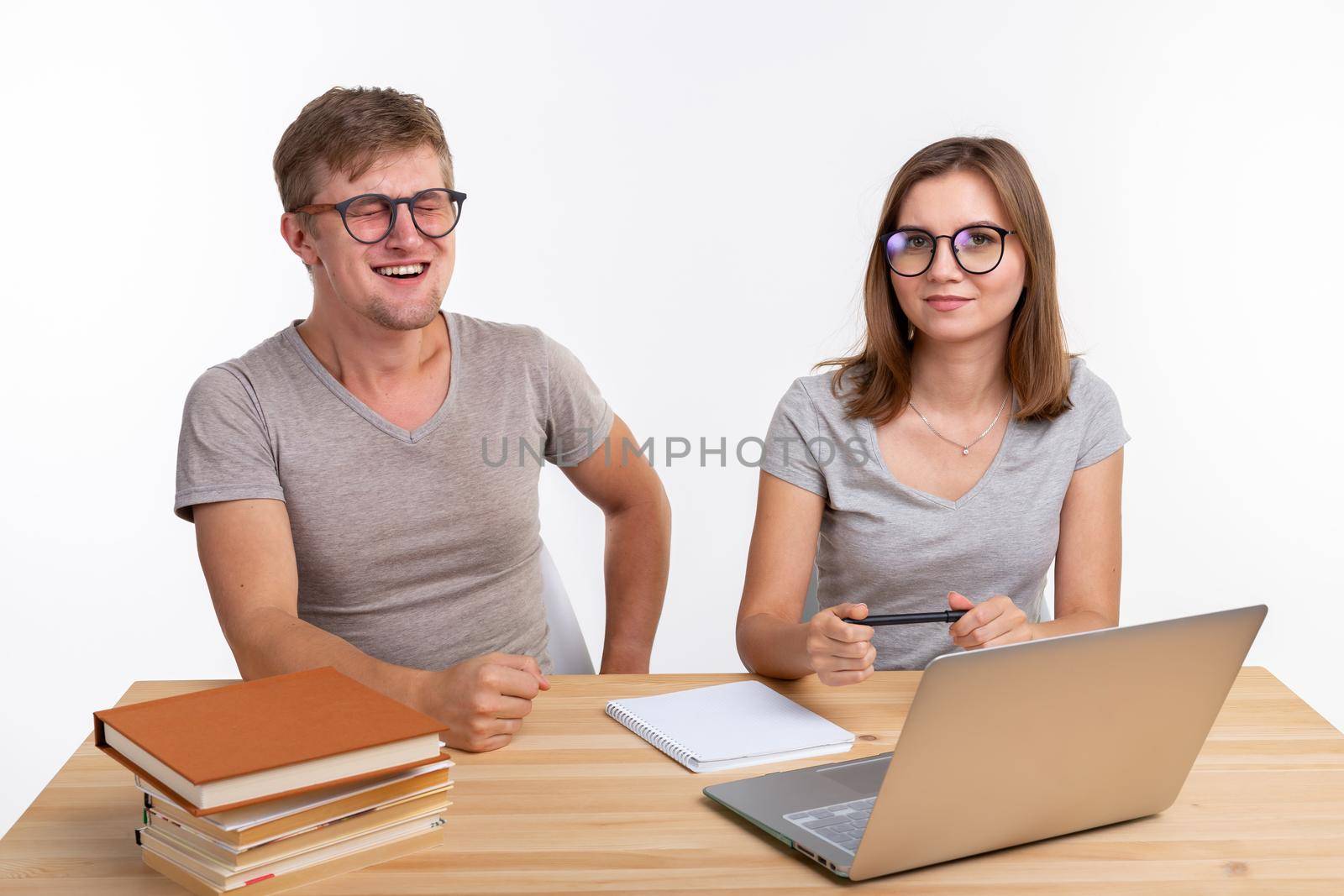 Education and people concept - couple of student doing exercises homework in laptop by Satura86
