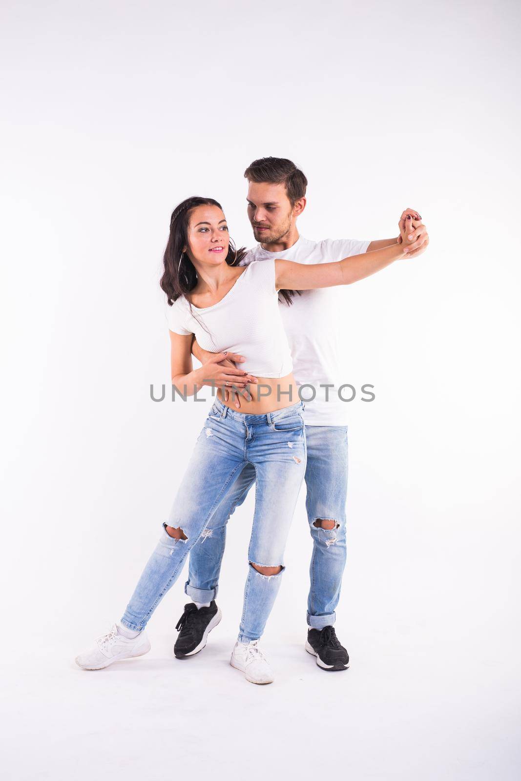 Young couple dancing social latin dance bachata, merengue, salsa. Two elegance pose on white background by Satura86