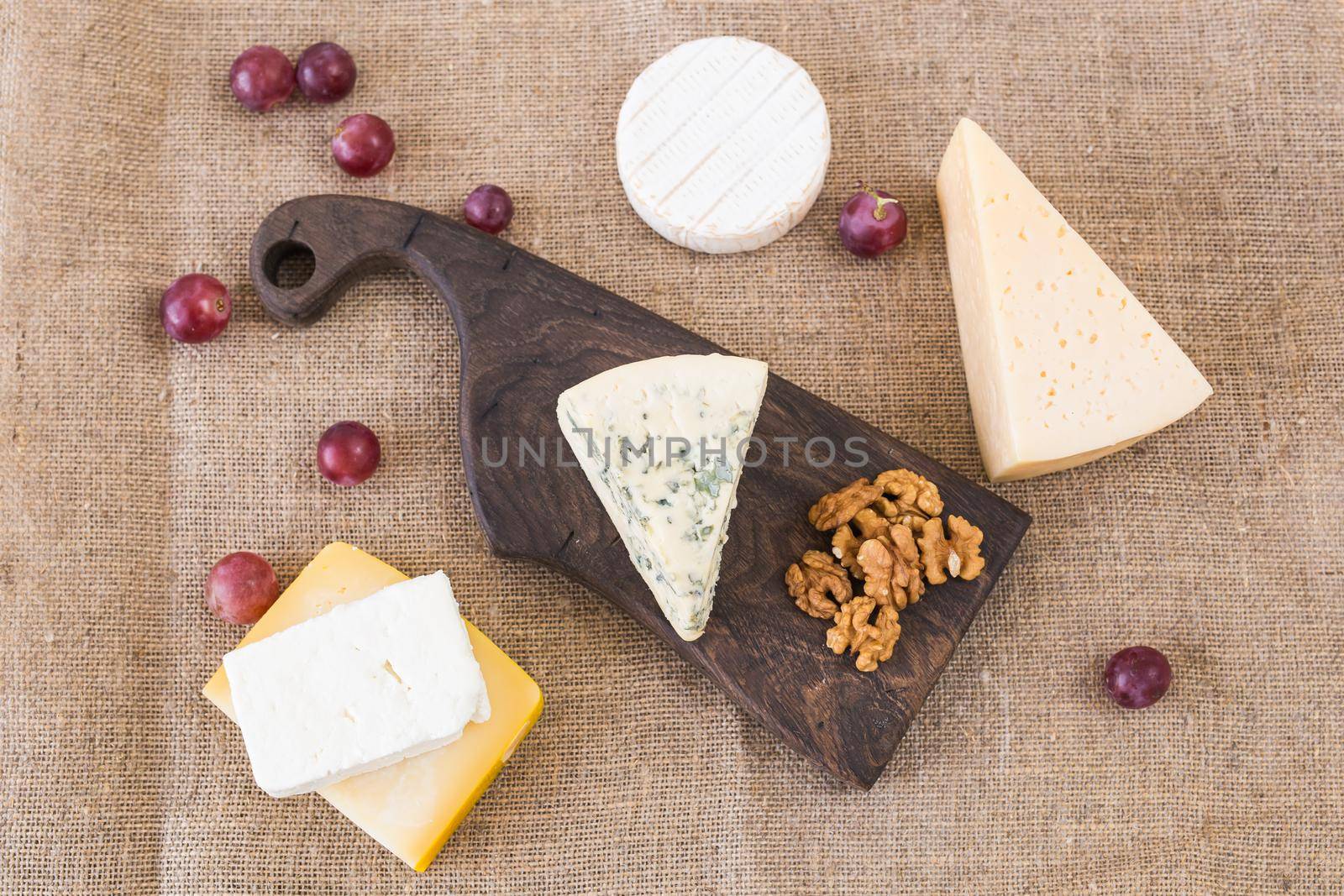 Various types of cheese, blue cheese and brie with grapes and nuts by Satura86