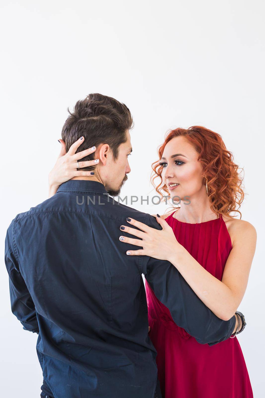 Social dance, bachata, kizomba, salsa, tango concept - Close up portrait of woman man dressed in beautiful outfits over white background by Satura86