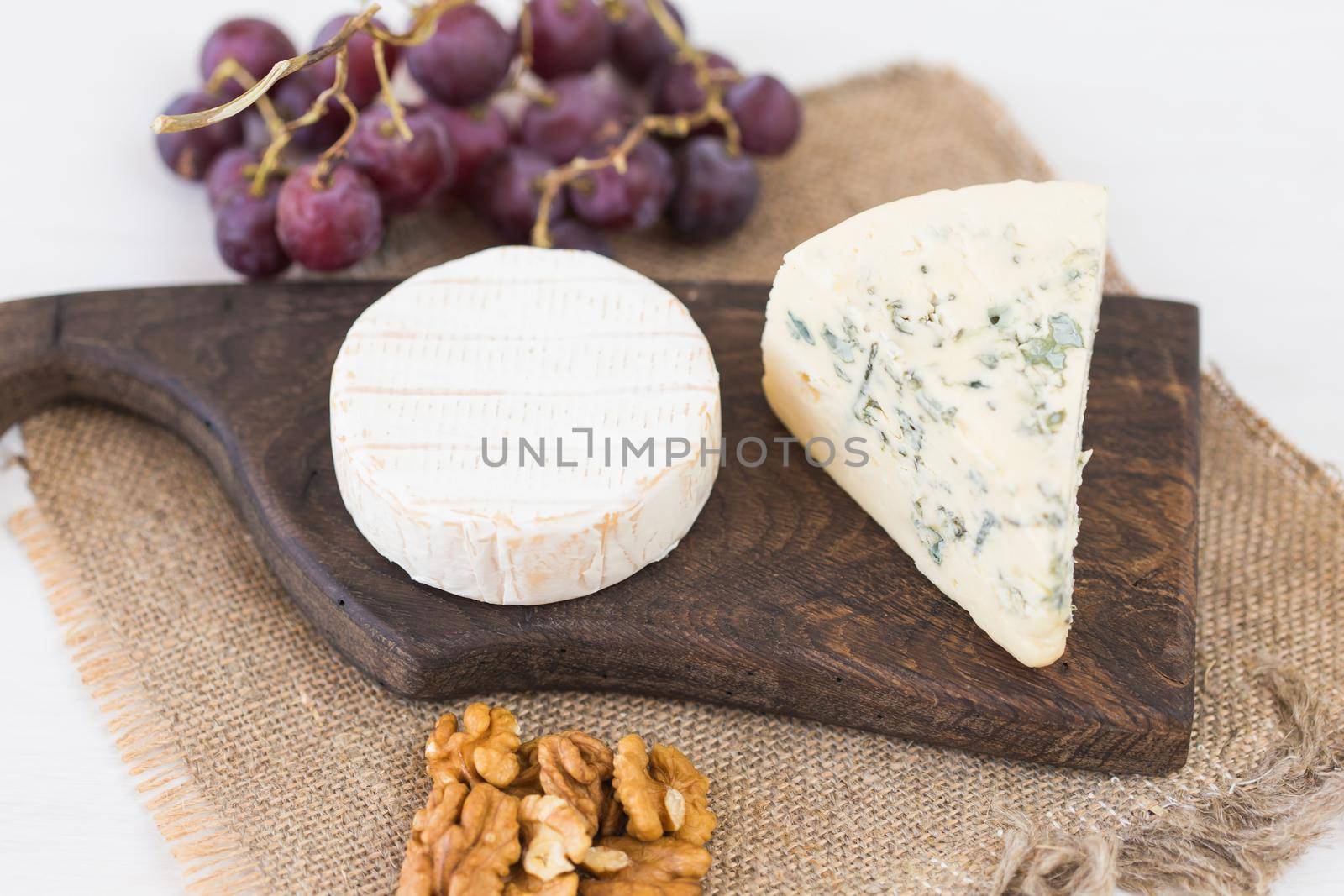 Blue cheese or brie with grapes and nuts.