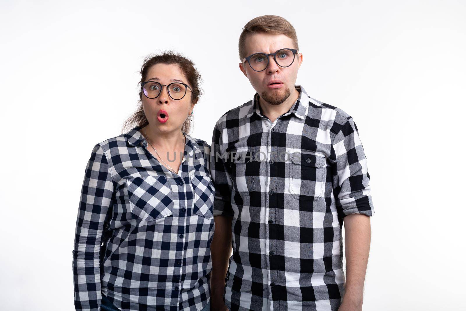People, geek and education concept - Two students with funny faces over white background by Satura86