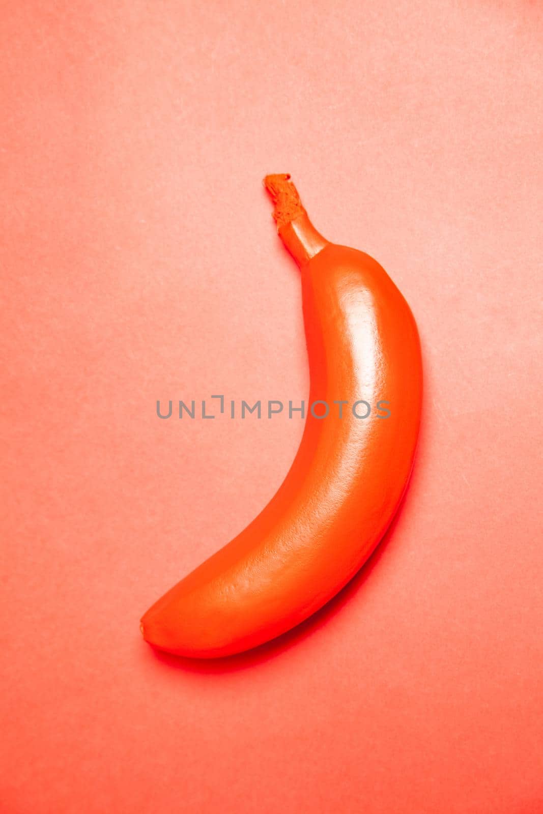 Red colored tropical banana on bright surface by Julenochek
