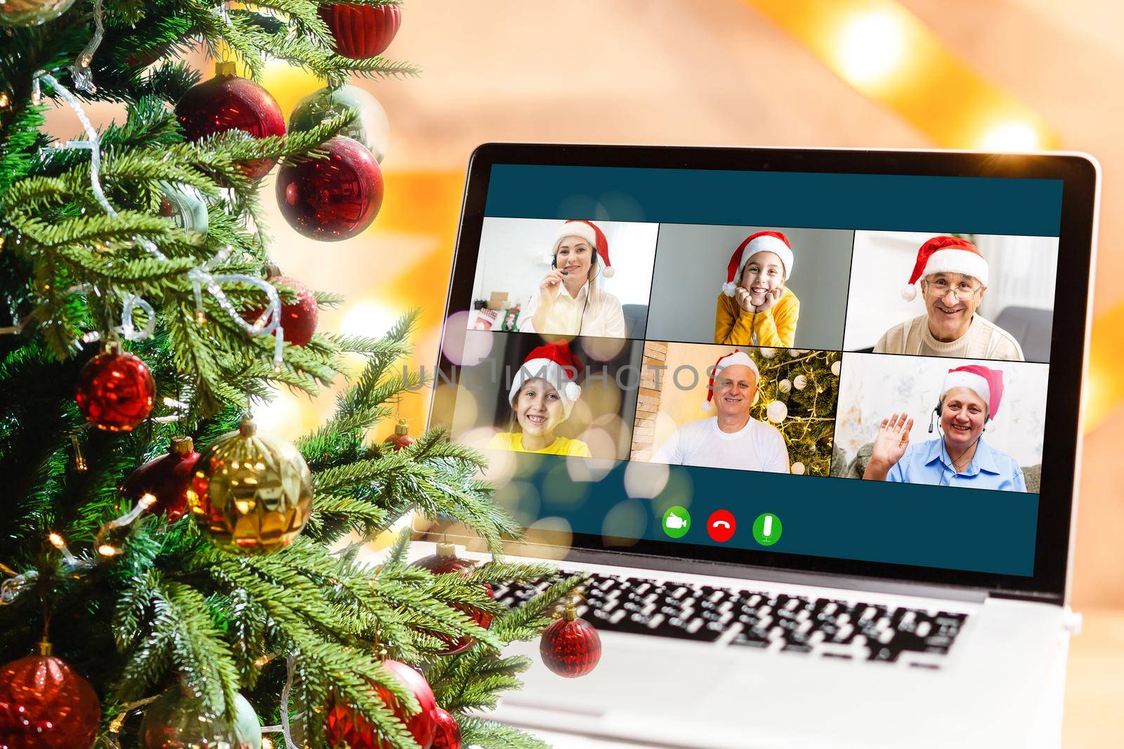 Christmas greetings online. a woman in a white sweater and red Santa hat uses a laptop to make video calls to friends, parents, and for online shopping by Andelov13
