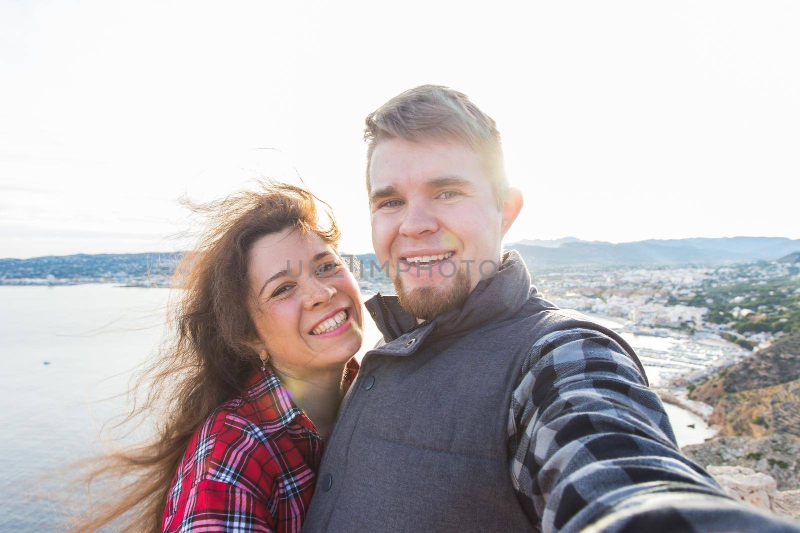 Travel, holidays and vacation concept - Lovely couple selfie near a sea.