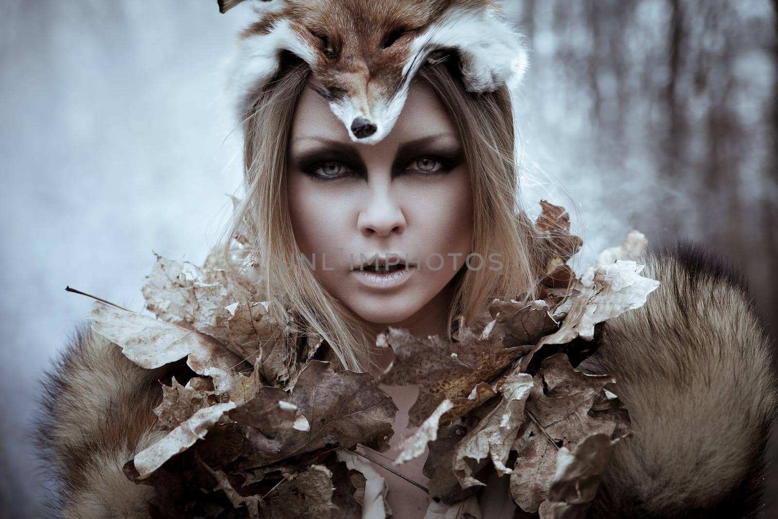 Romantic wild beauty tribal woman in fox costume in wild forest. Vintage styled