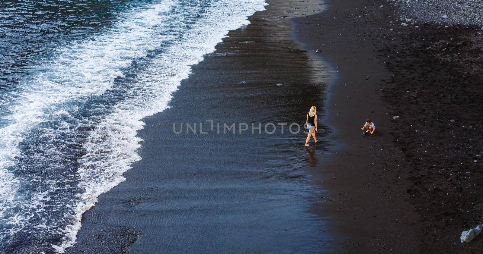 Family holiday on Tenerife, Spain, Europe. Mother and daughter outdoors on ocean. Portrait travel tourists - mom with child. Positive human emotions, active lifestyles. Happy young family on sea beach