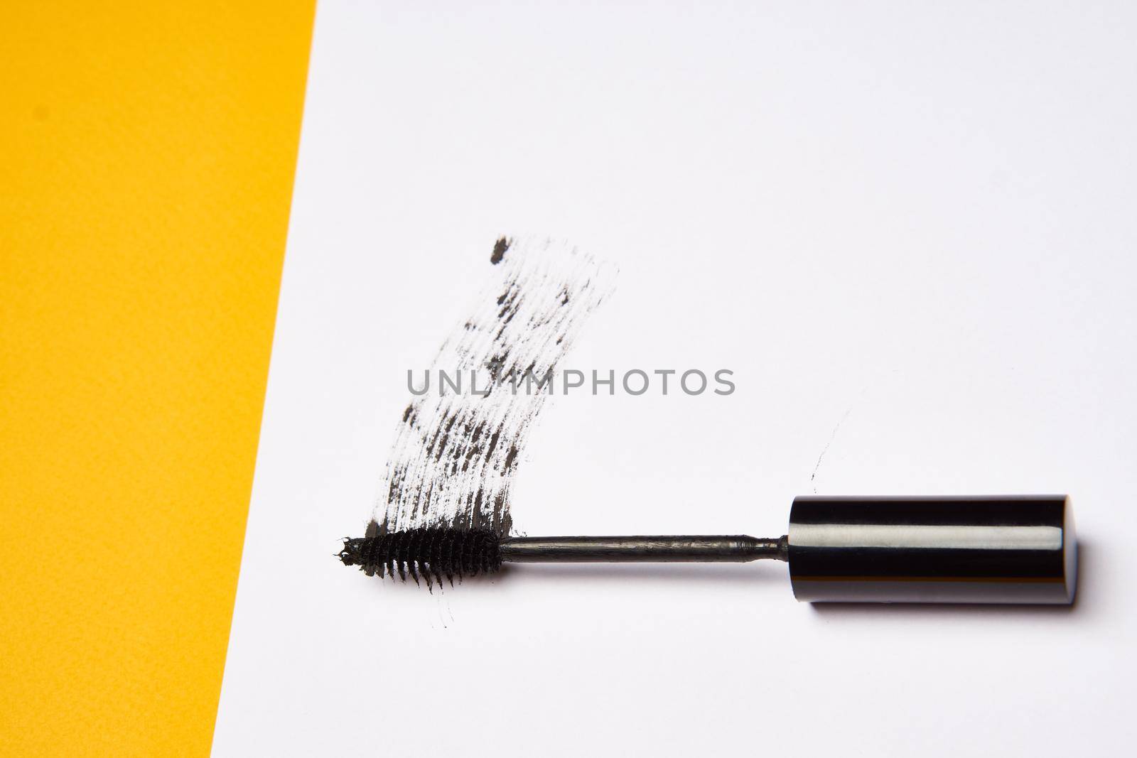 cosmetics mascara brushes decoration accessories yellow background by Vichizh