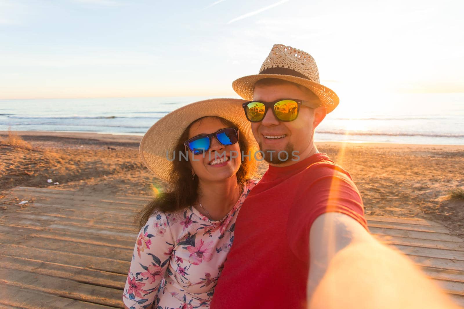 Travel, summer and holiday concept - Lovely couple taking selfie on a beach by Satura86