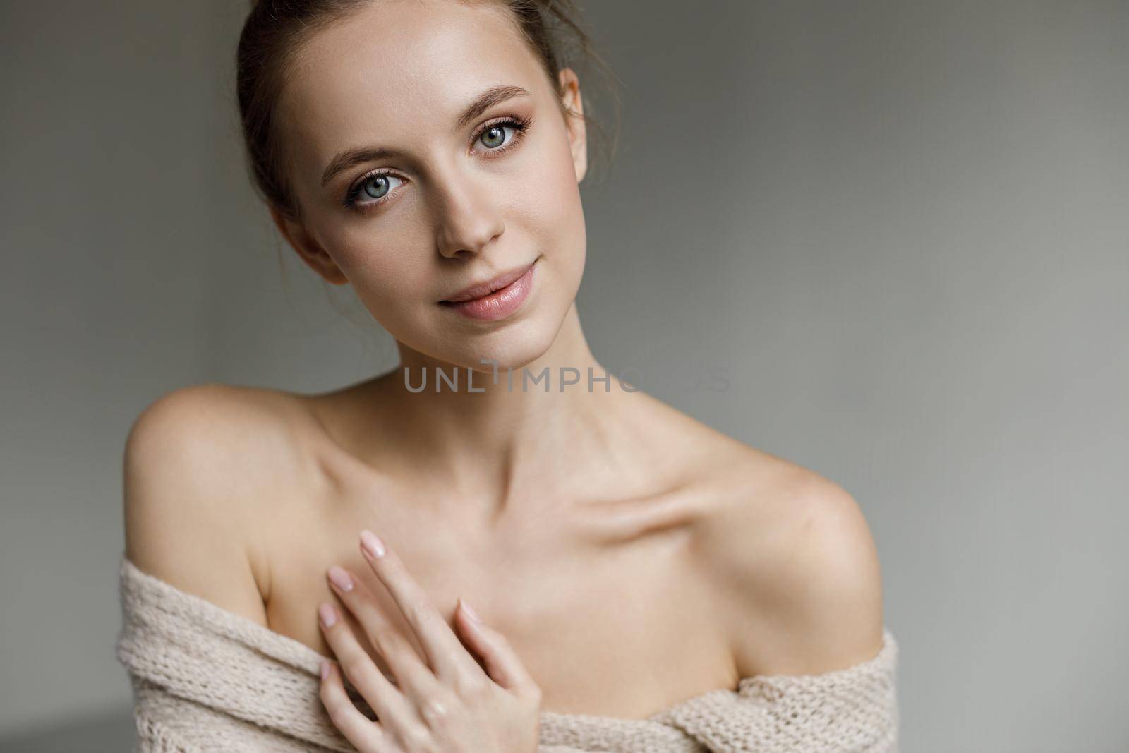 Portrait of a young pretty woman indoor in studio, skin wellness by splash