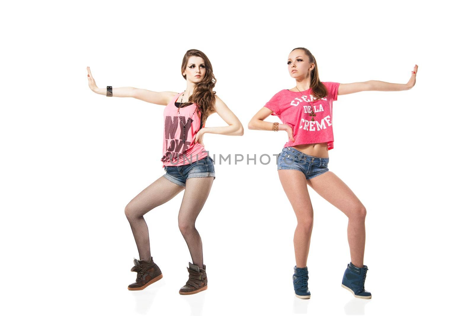 cool looking two dancing women isolated on white background