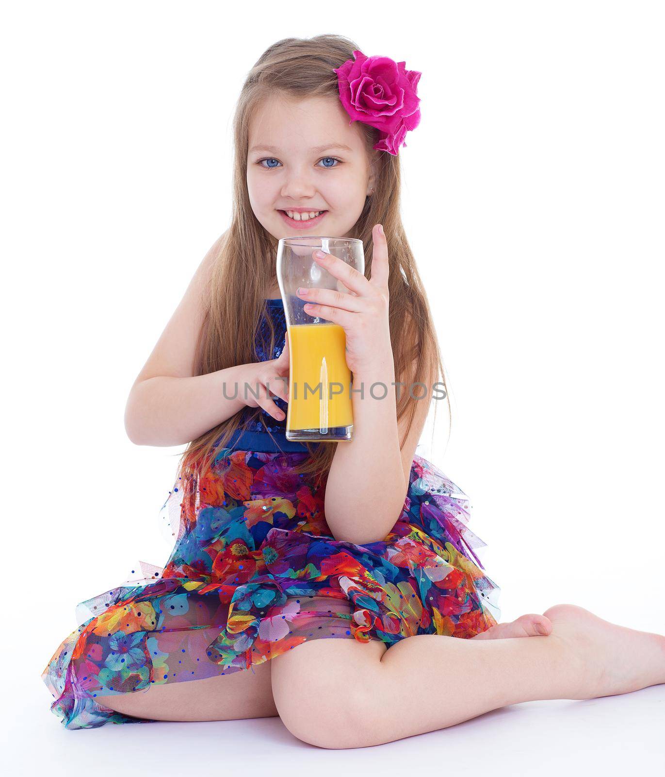 girl, fashion, rose in her hair and orange juice in a glass- Portrait of happy little girl drinking orange juice