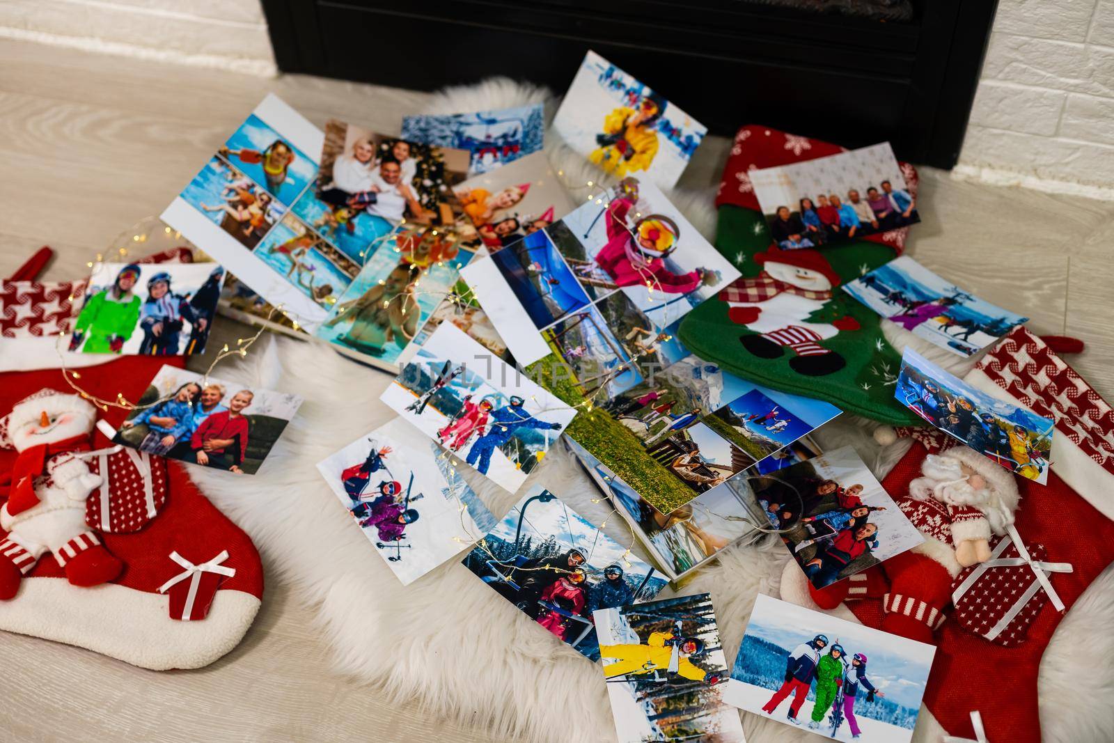 photo books lie near the fireplace at christmas