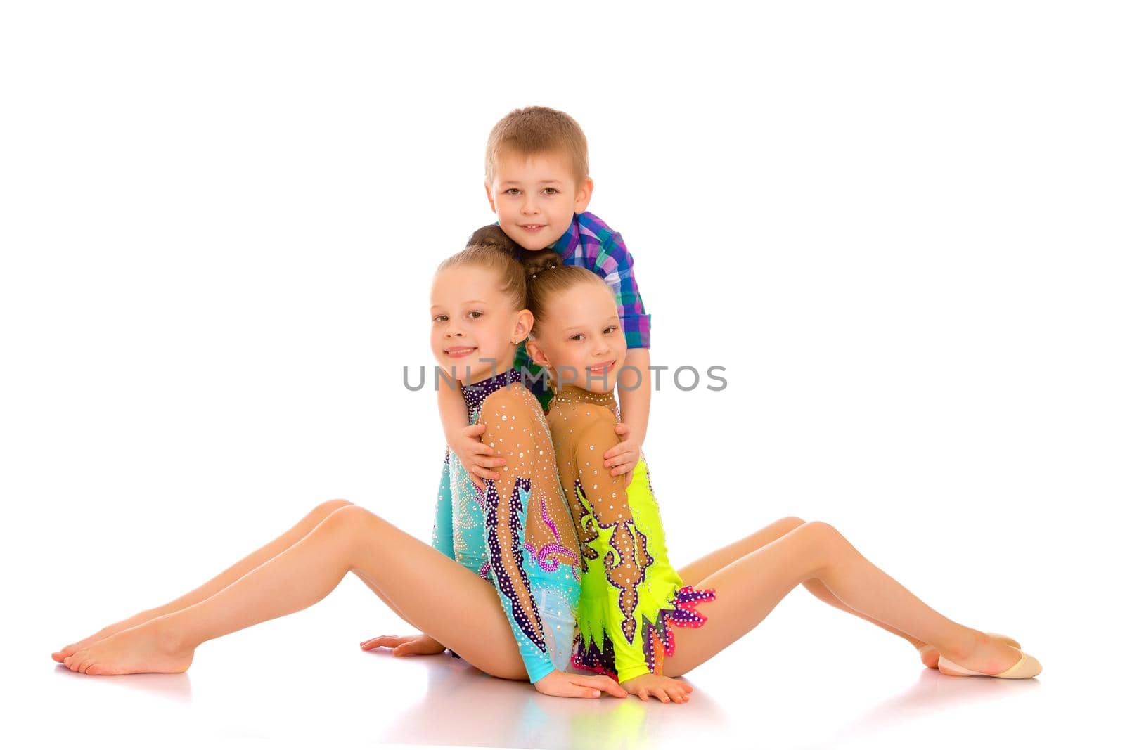 Cheerful girls, and the little boy their brother together embrac by kolesnikov_studio