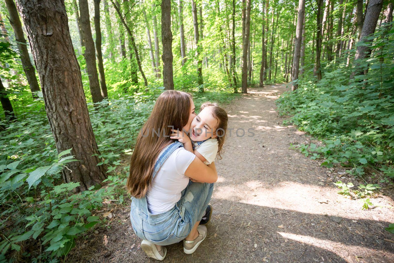 Young mother received a surprise from her daughter feeling excited open the mouth and looking at the gift in amazement in mother's day. Holidays, birthday and presents concept