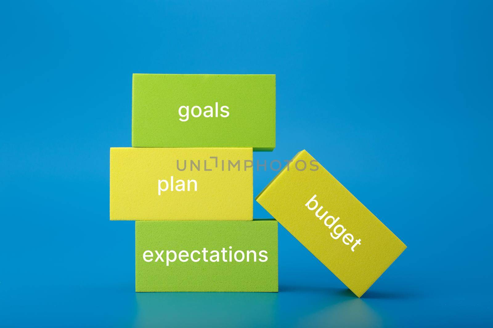 Business plan concept 2022. Business plan concept. Text budget, plan, goals, expectations written on colored rectangles against blue background. Financial goals for 2022