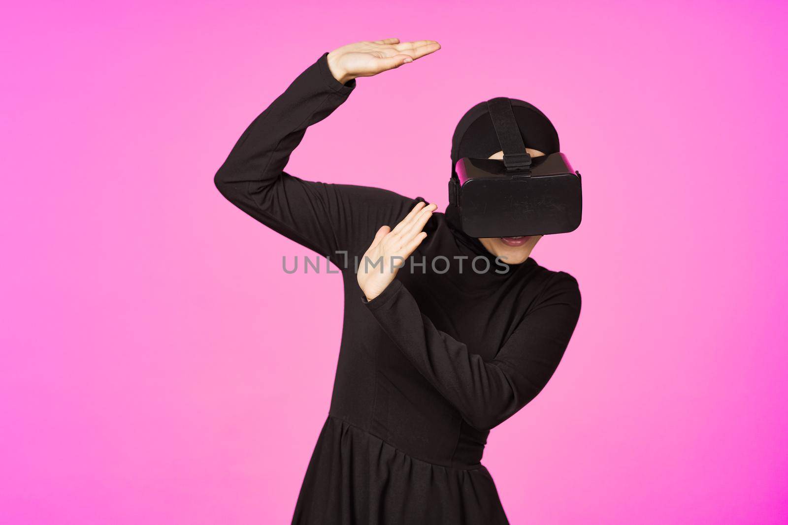 woman in black hijab glasses virtual reality technology movie watching. High quality photo