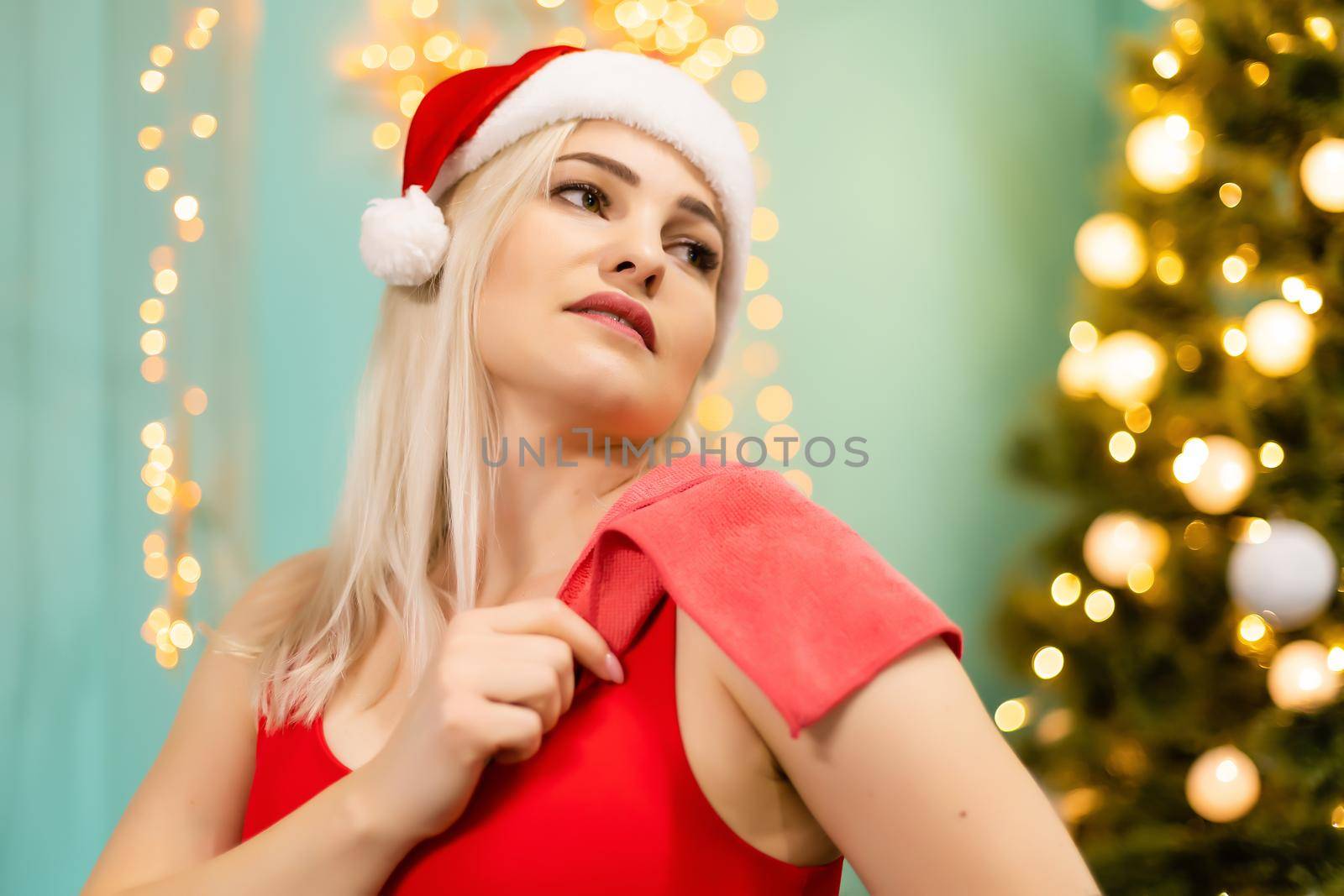 young woman goes in for sports near christmas tree at the gym