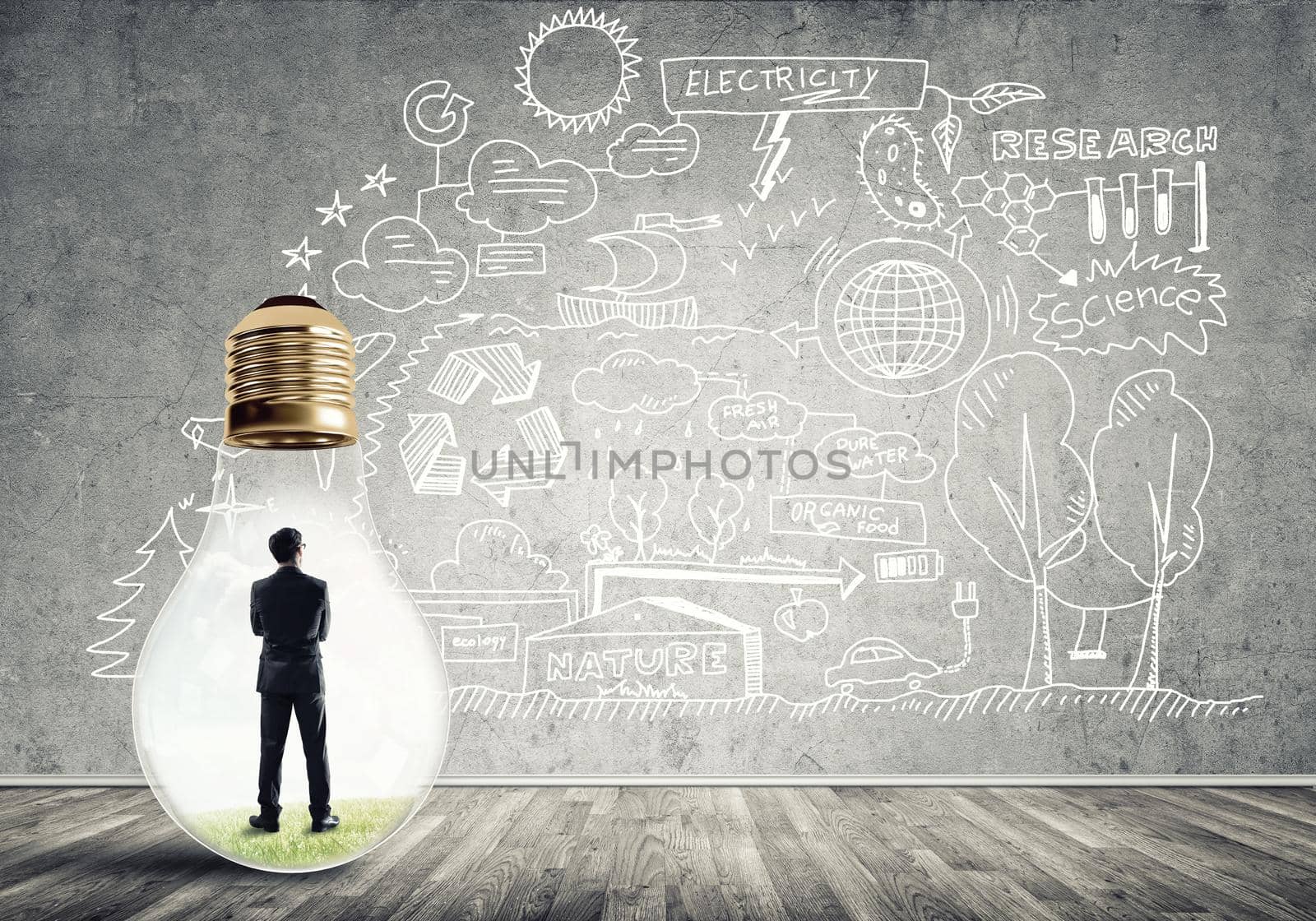Businessman inside of light bulb in empty concrete room and sketches on wall