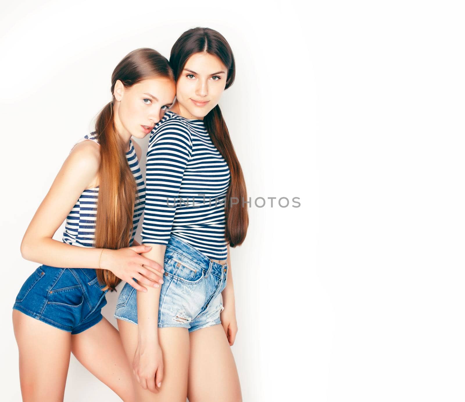 best friends teenage girls together having fun, posing emotional on white background, besties happy smiling, lifestyle people concept close up.