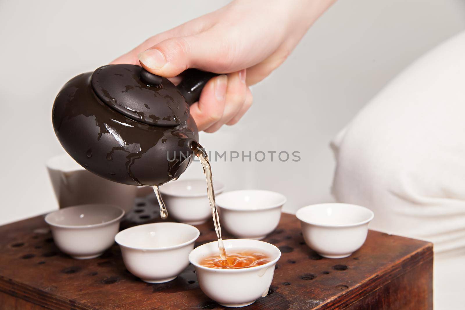 Chinese tea ceremony is perfomed by tea master in kimono