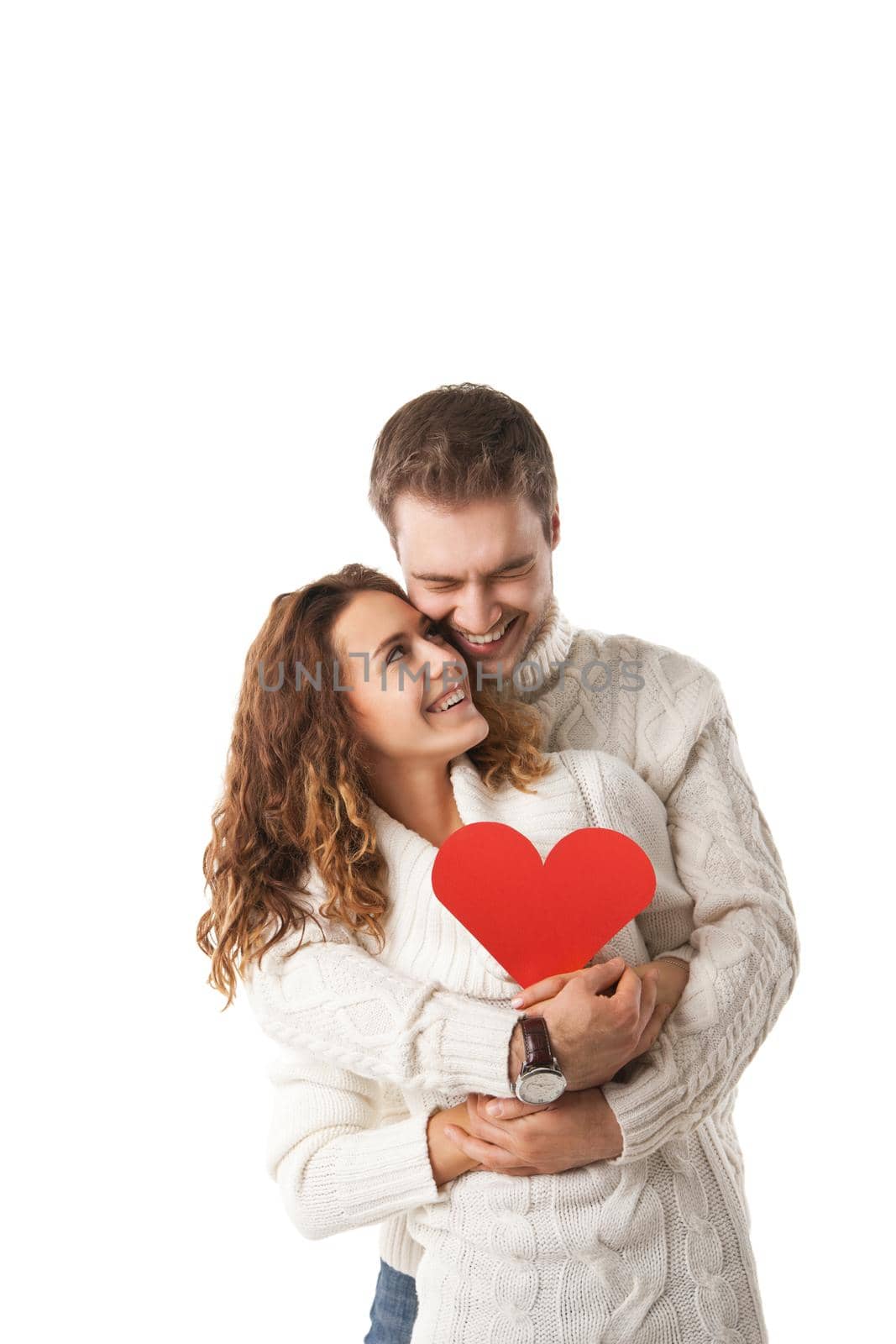 beautiful young couple holding a red heart isolated over white background