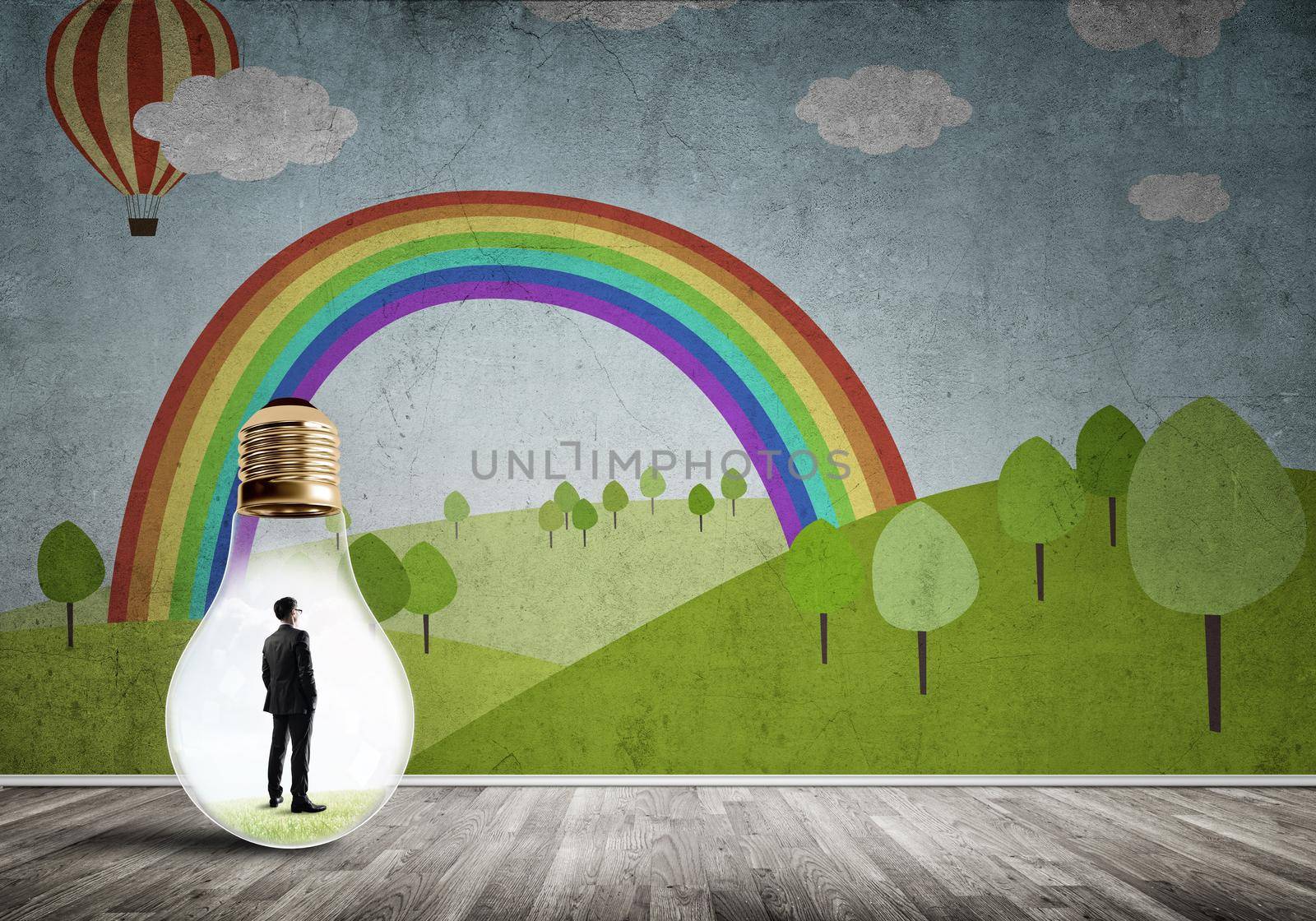 Businessman inside light bulb in room against nature drawn concept