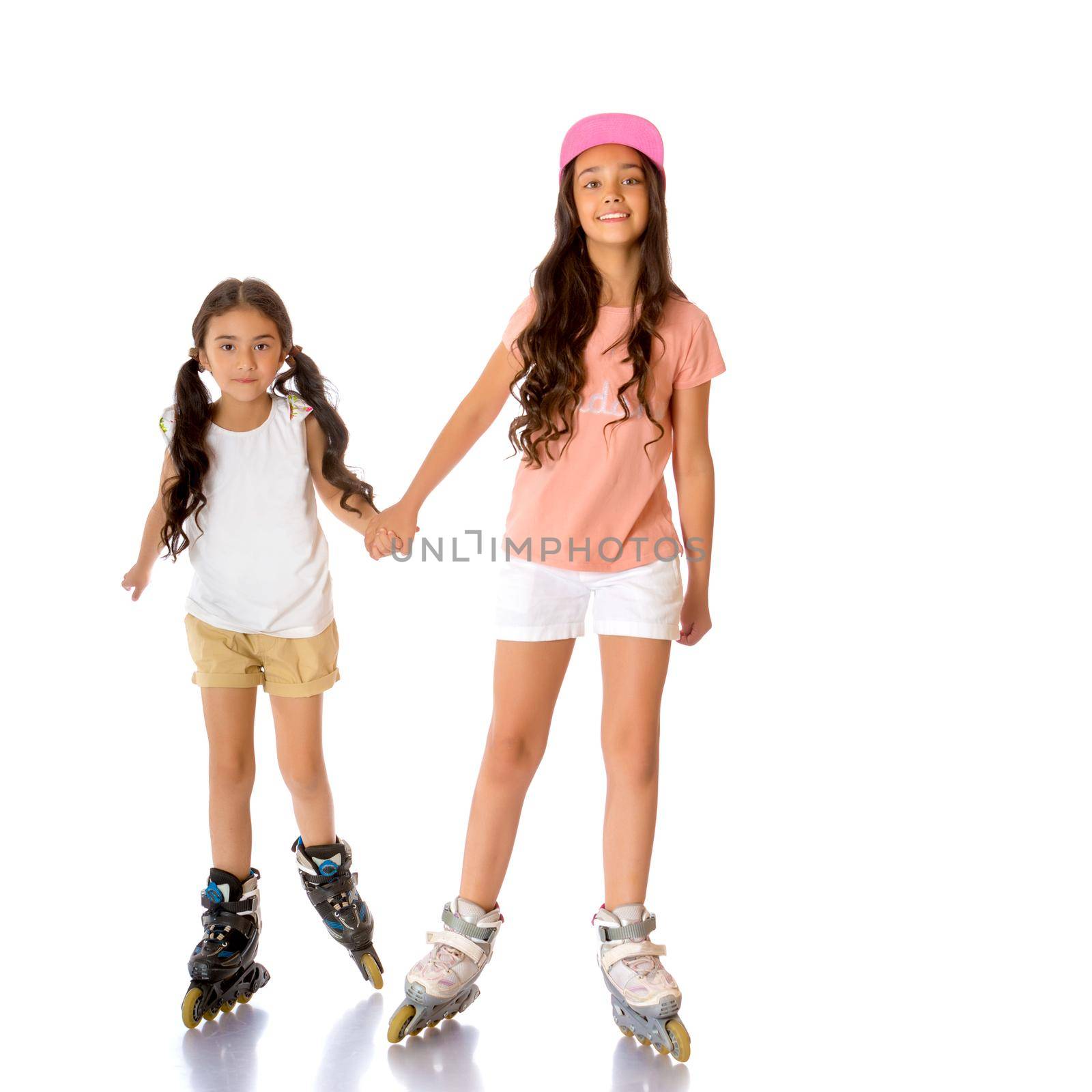 two Asian girls are roller-skating by kolesnikov_studio