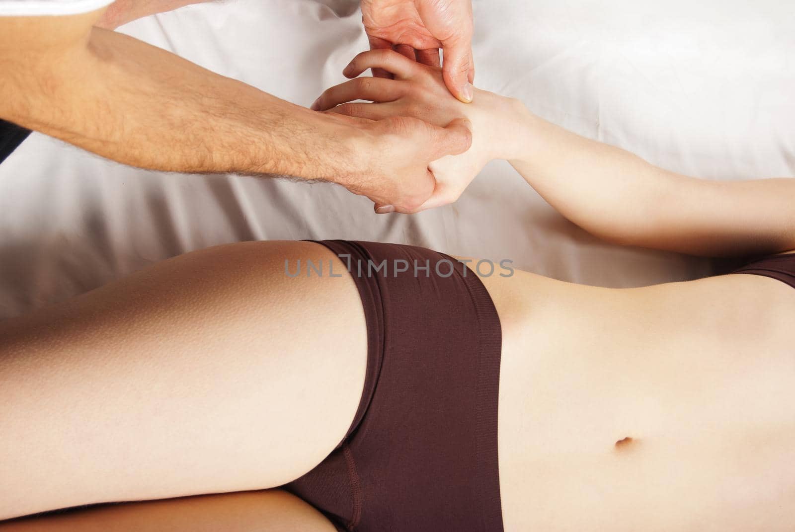girl getting a massage - hands massaging her hand - A pretty woman getting a hand massage