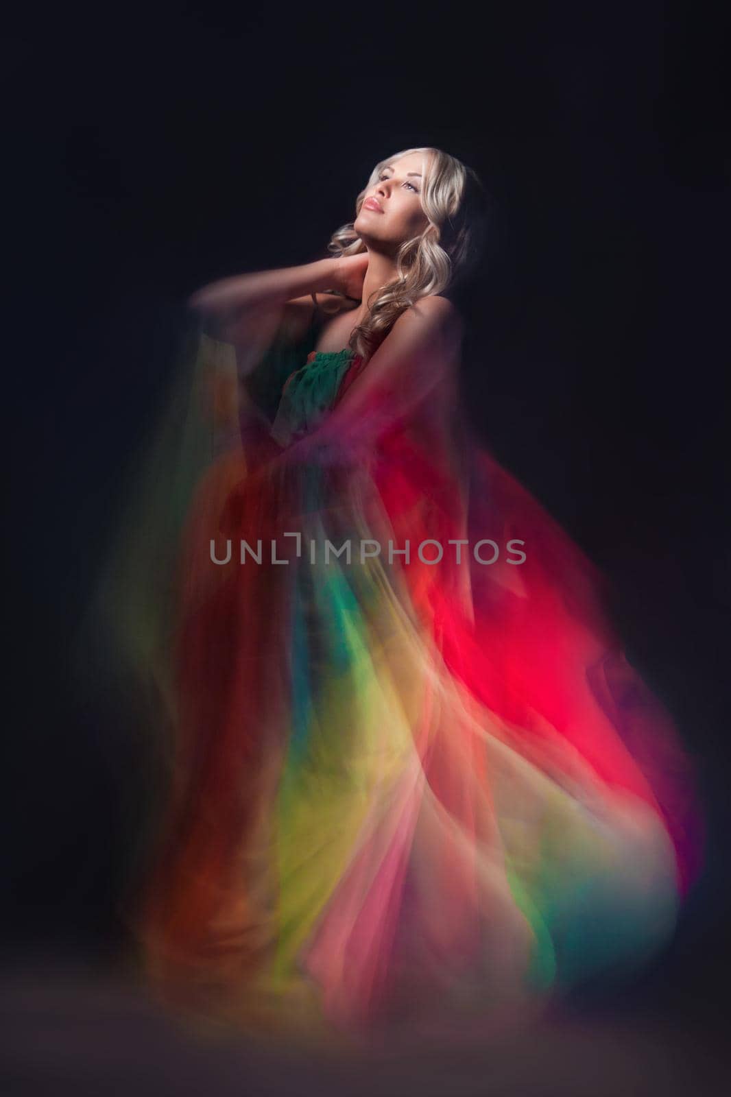 Model in colorful dress on black background by Julenochek