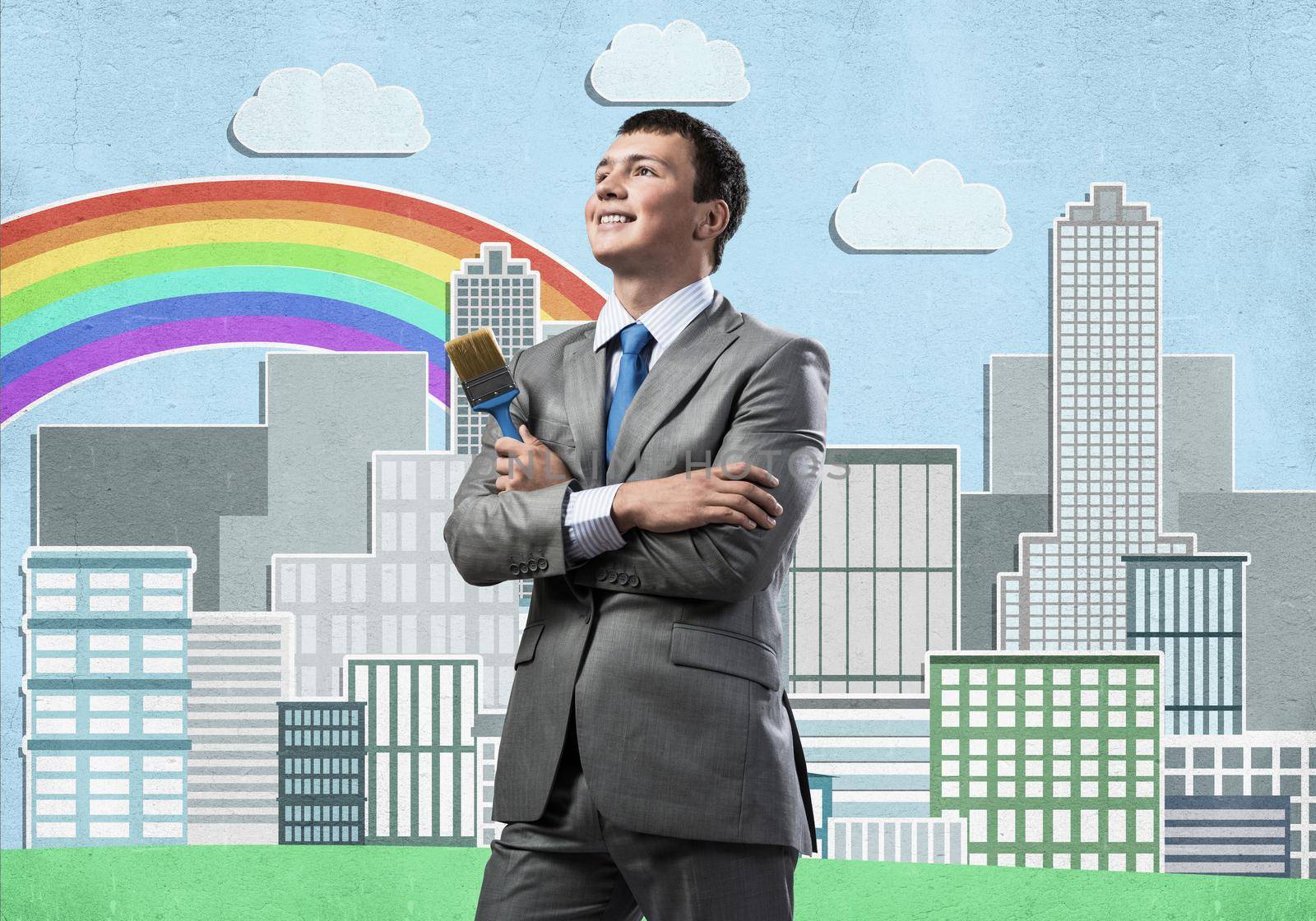 Confident and creative businessman painter standing with arms folded. Happy handsome man in business suit and tie holding paintbrush on city background. Cityscape illustration with colorful rainbow.