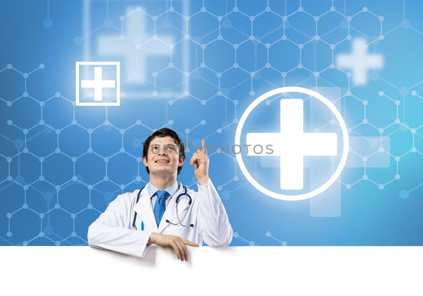 Young handsome doctor holding white blank banner. Place your text