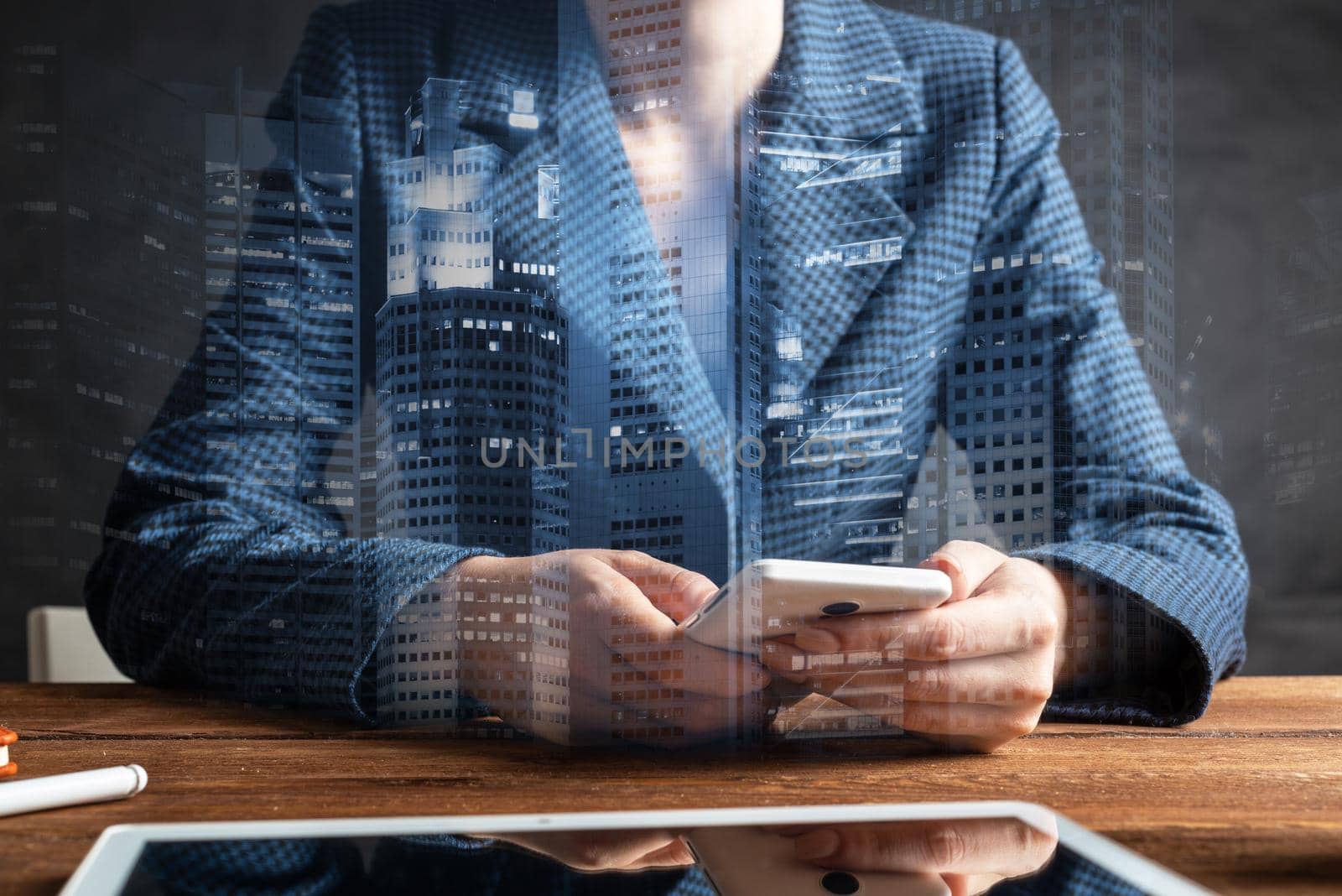 Businesswoman using mobile phone at desk. Close up woman hands and tablet computer. Mobile communication concept with chatting woman. Digital technology in strategy planning and company management