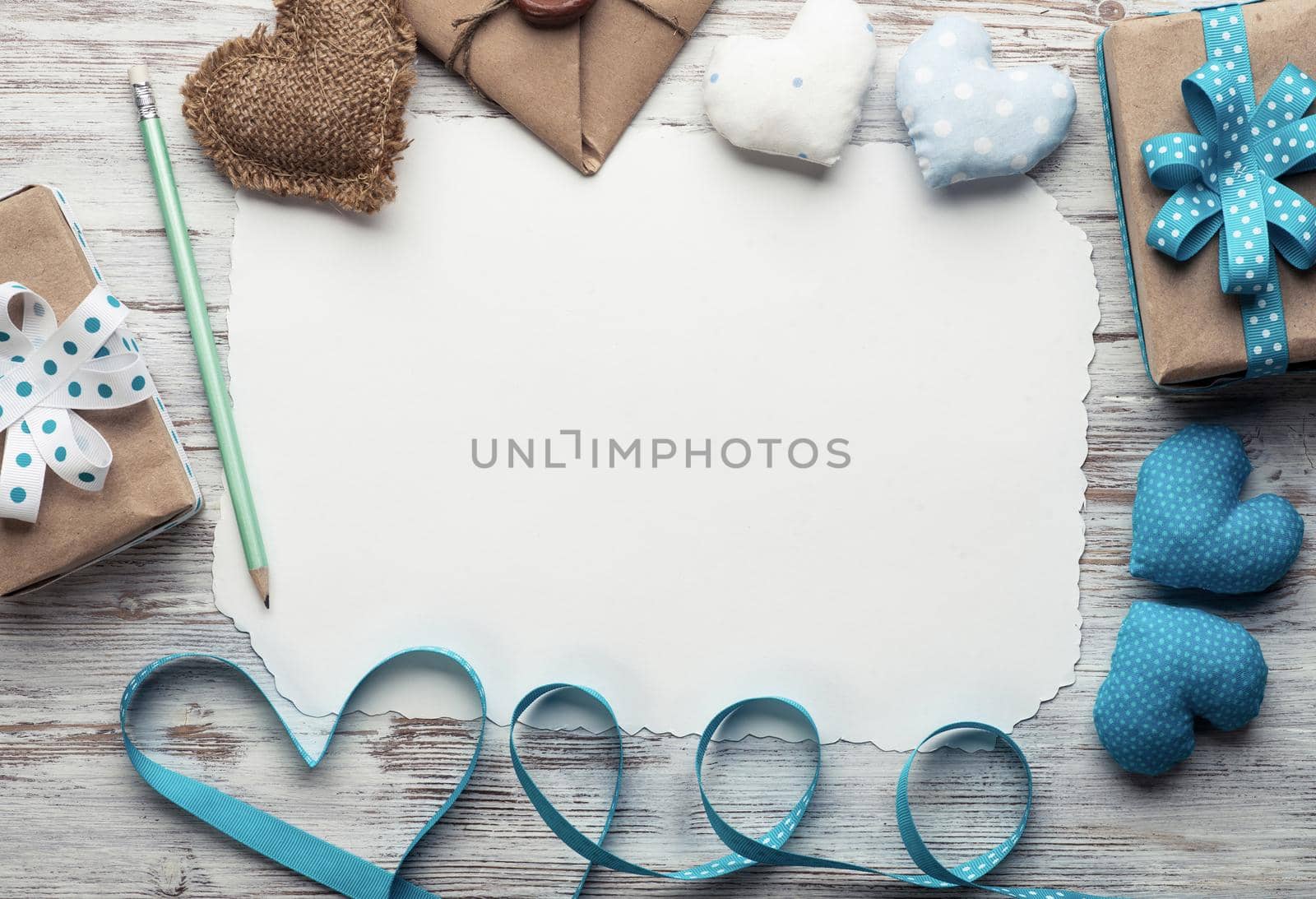 Flat lay composition with fabric love hearts and ribbon. Blank sheet of white paper on vintage wooden table. Declaration of love letter. Saint Valentine's day congratulation. Romantic event invitation