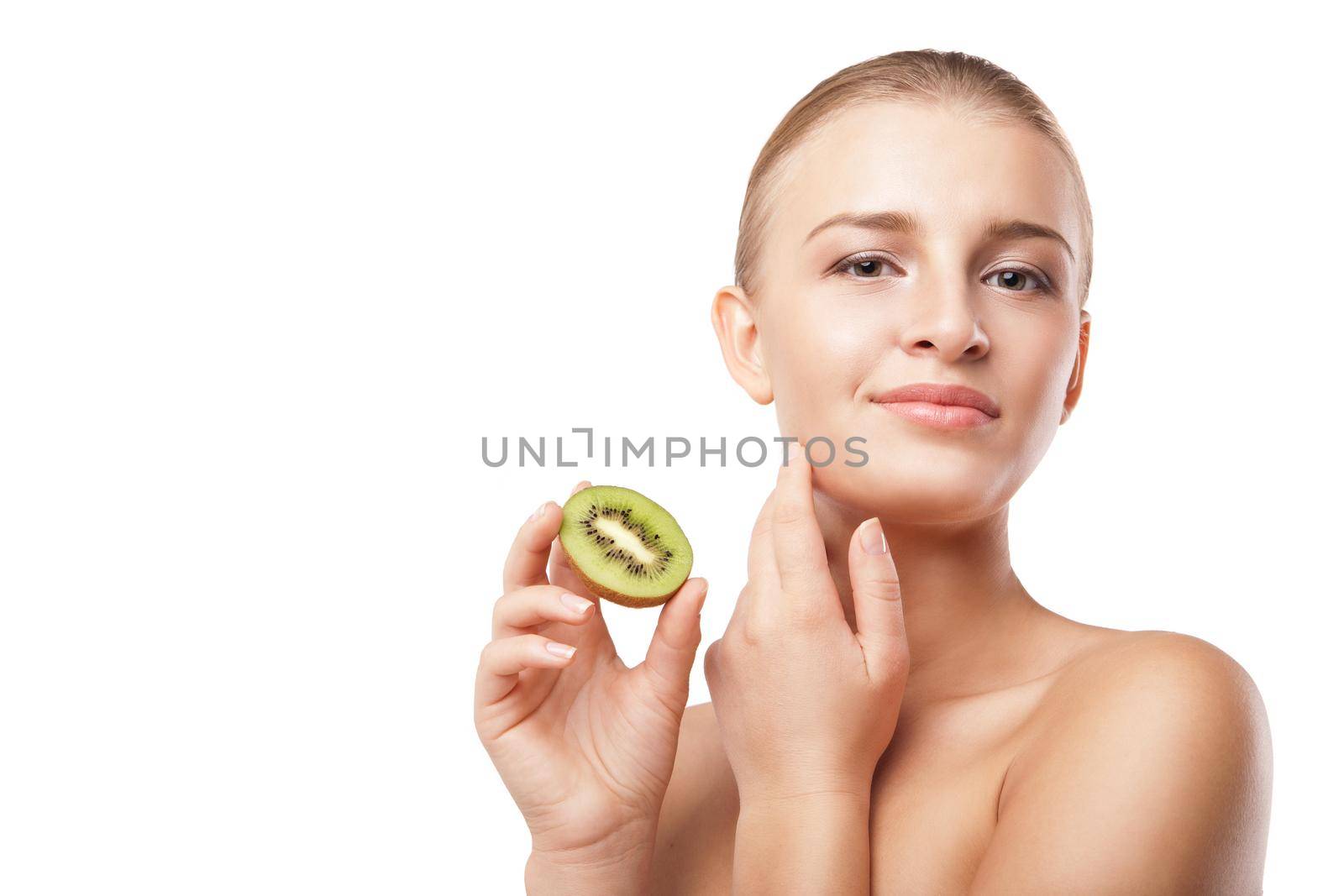 Beautiful smiling woman holding piece of kiwi. Beauty shot