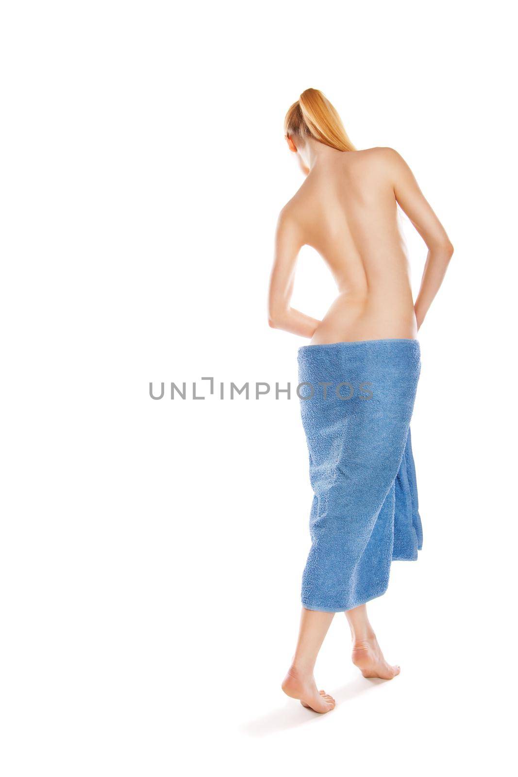 slim young woman after bath with blue towel over white
