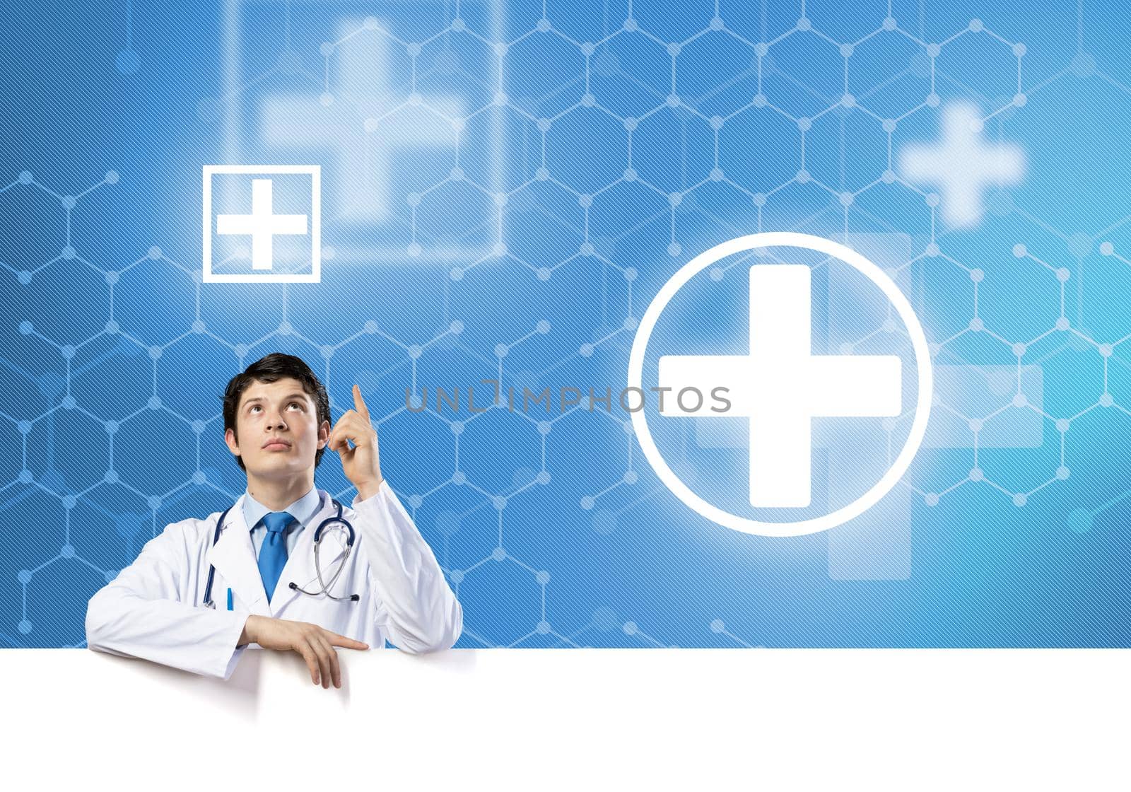 Young handsome doctor holding white blank banner. Place your text