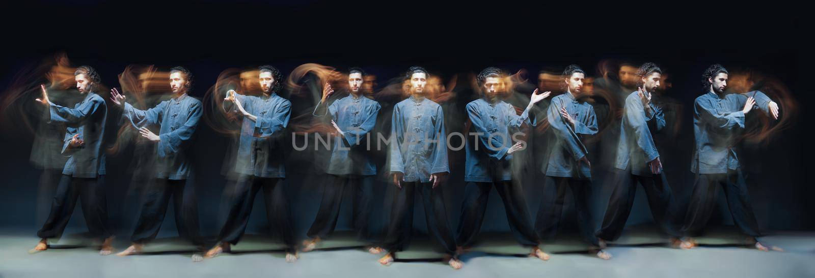 full-length portrait of man in kimono excercising Martial Arts on black bacground with multiexposition