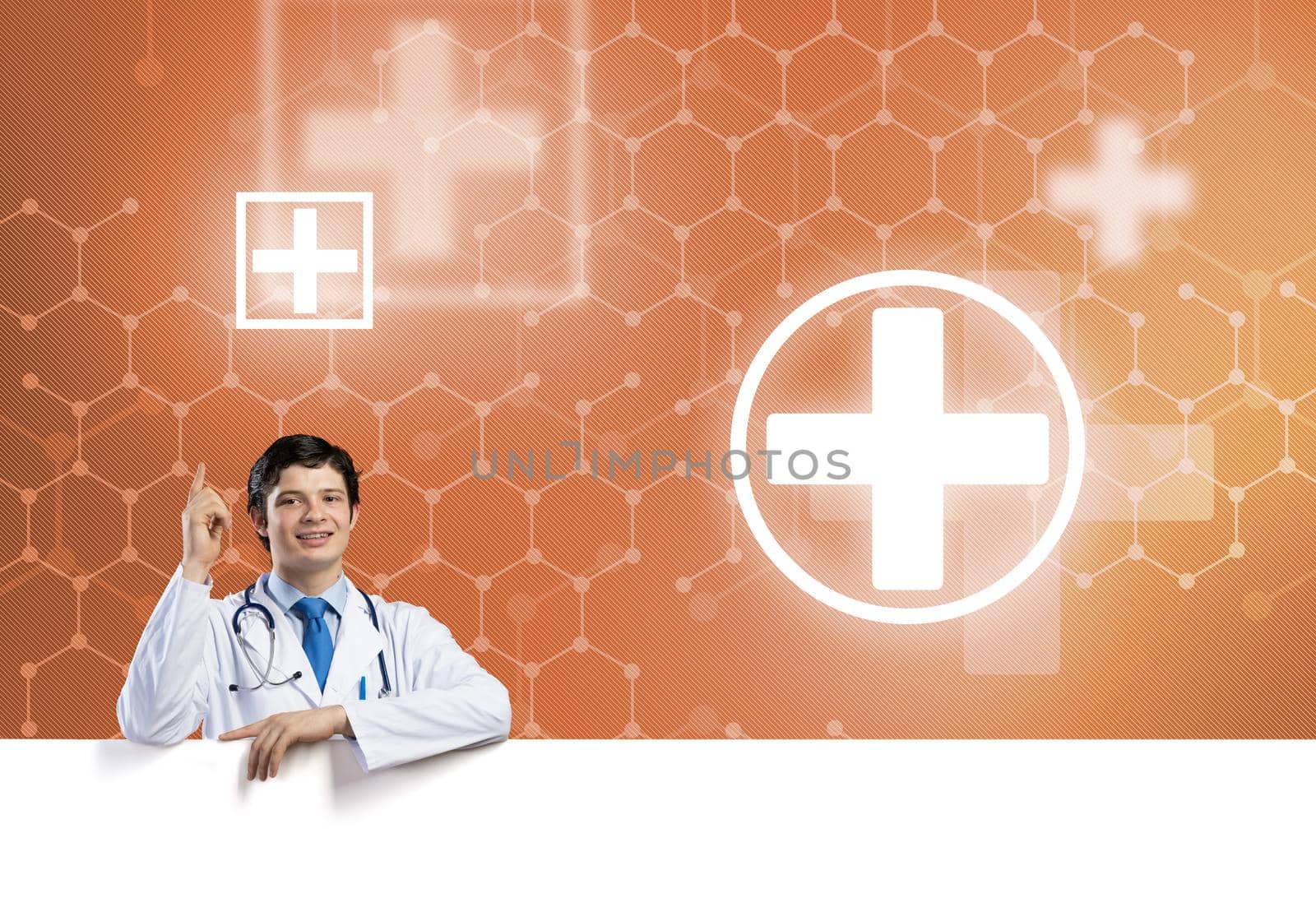 Young handsome doctor holding white blank banner. Place your text
