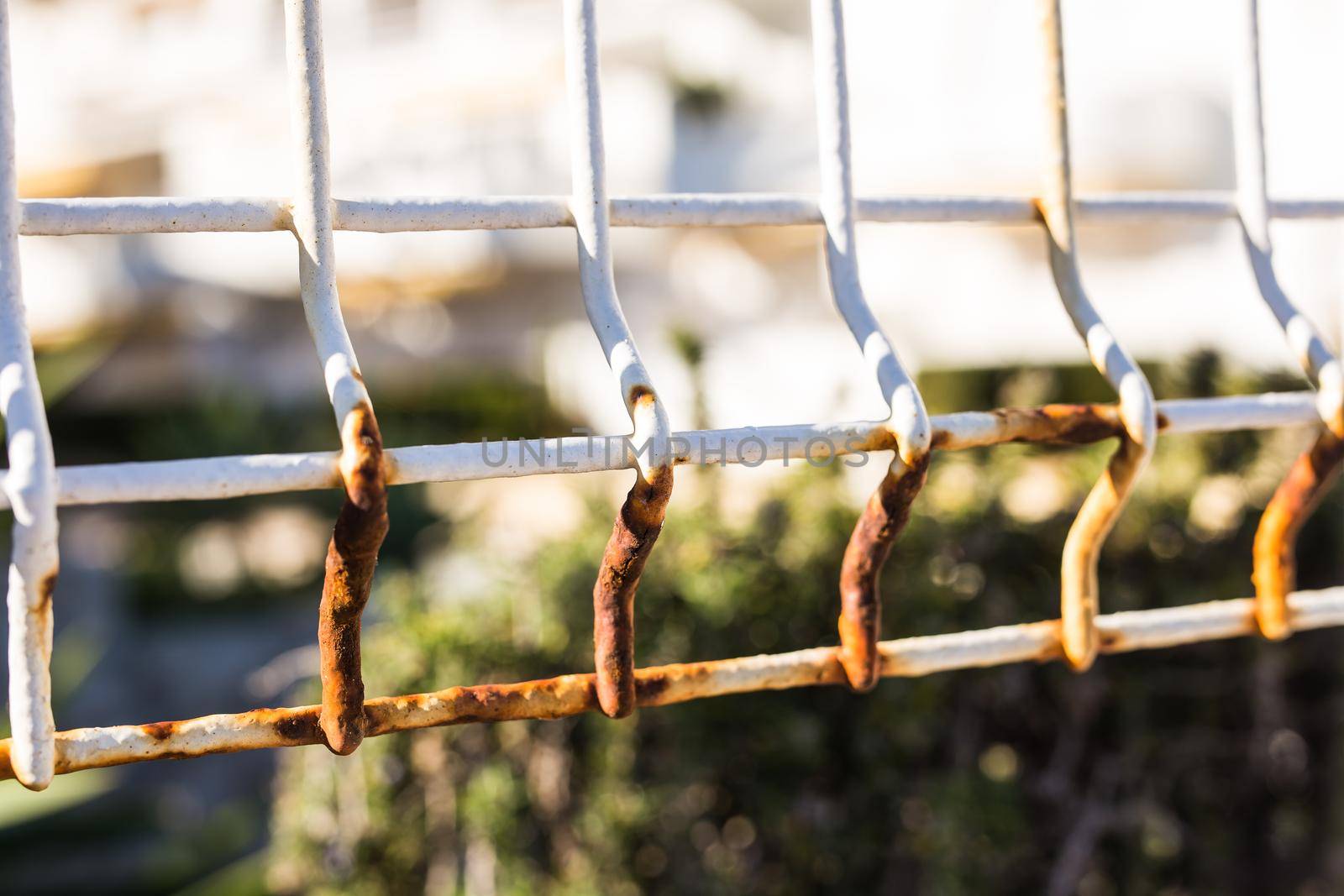 Exterior and design concept - Old white rusty fence, close up.