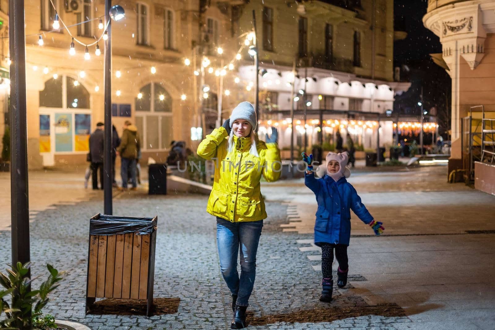 Mother and daughter are walking around the city on Christmas and New Year holidays.