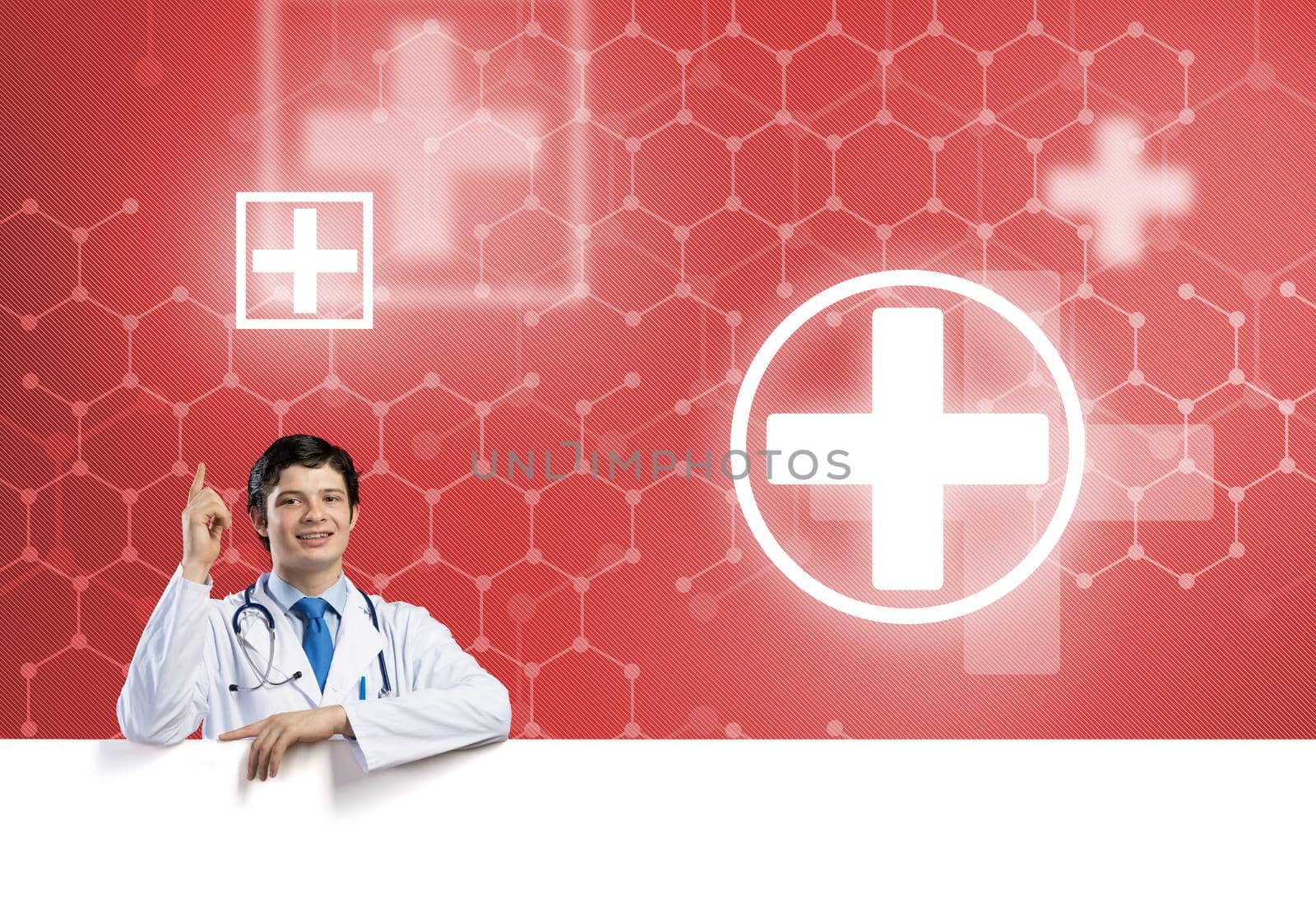 Young handsome doctor holding white blank banner. Place your text