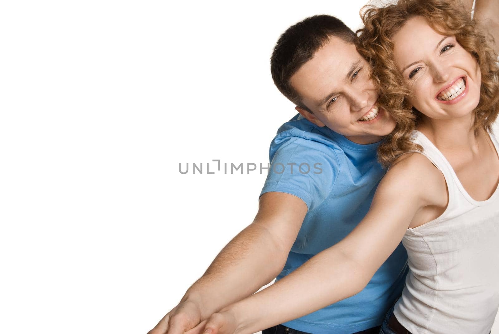 Portrait of a beautiful young happy smiling couple - isolated