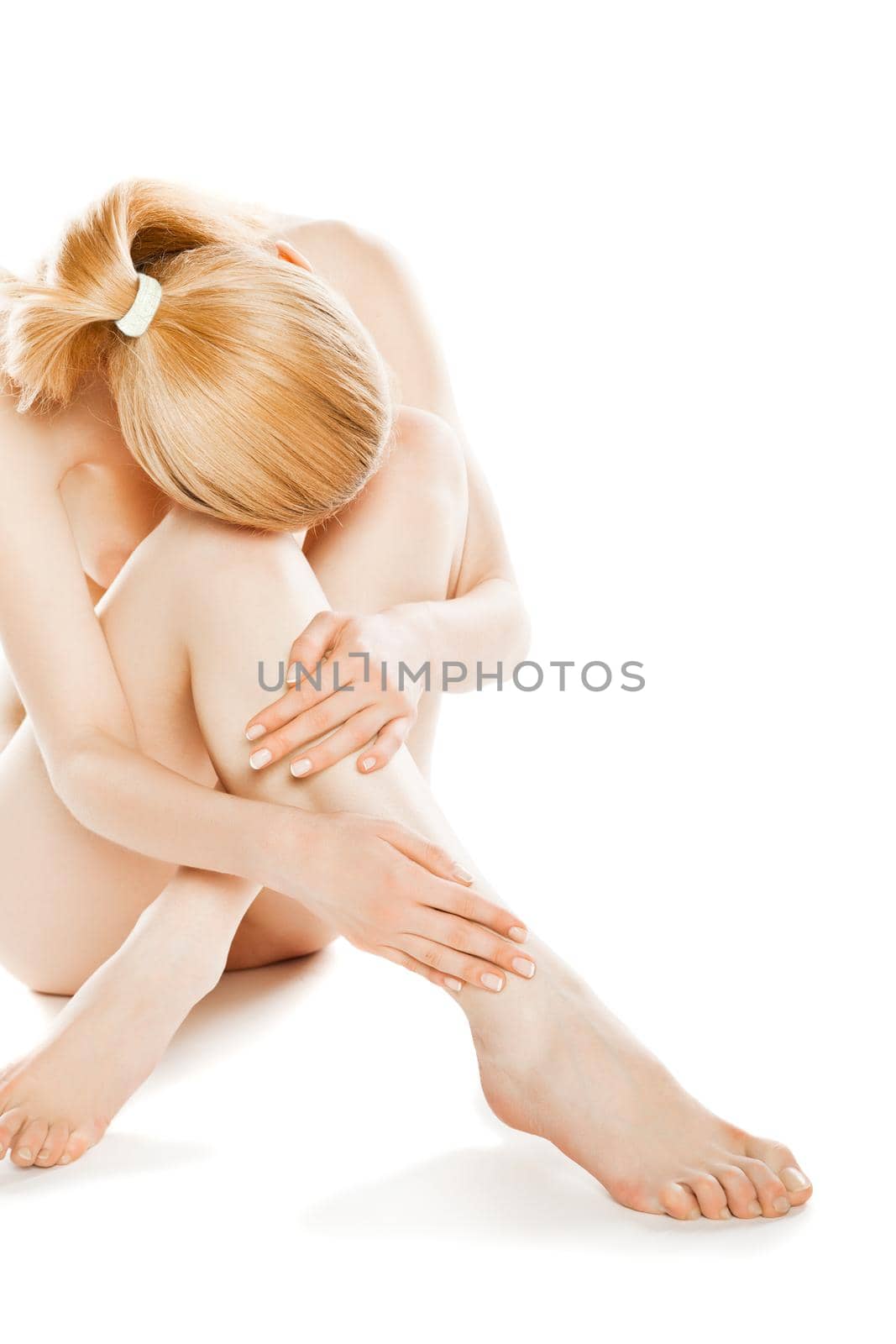 picture of healthy naked woman sitting in studio over white