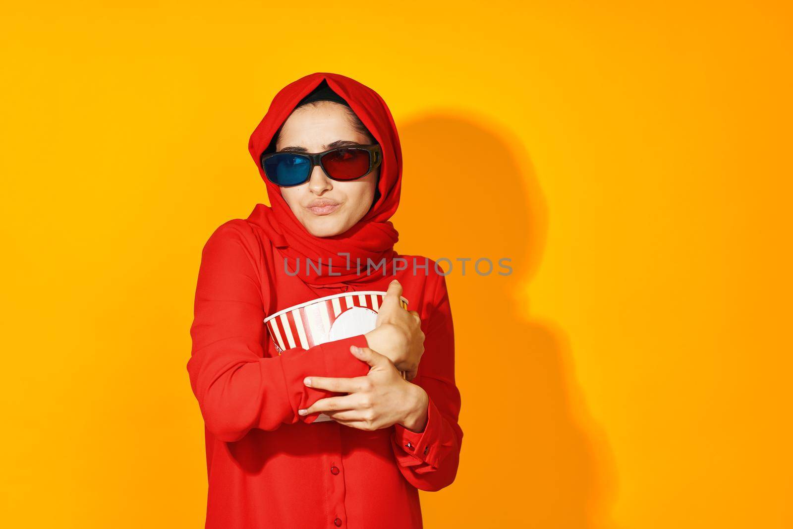 pretty woman 3d glasses technology watching movie popcorn yellow background. High quality photo